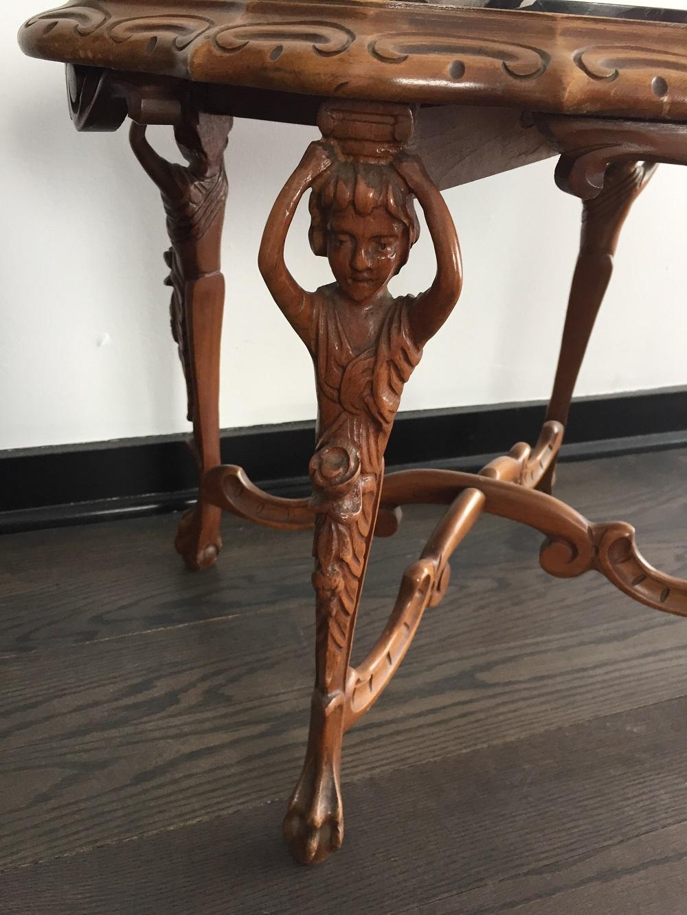 One of a kind French antique table with carved legs 
Black veined marble 
intricate detail
legs carved as figures from single piece of wood 
ball and claw feet 
incredible!