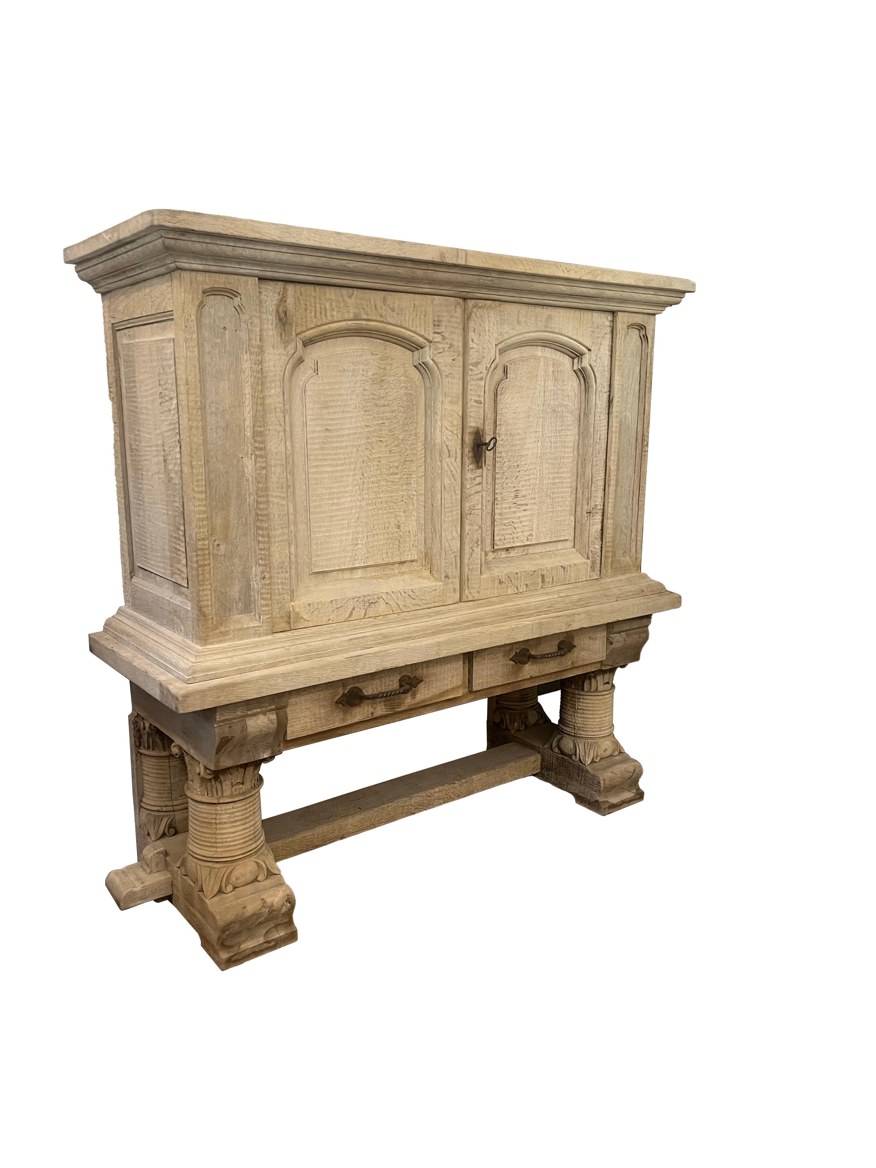 Presenting a captivating French Bleached Oak Cabinet, a versatile two-piece ensemble that seamlessly marries functionality with timeless elegance. This remarkable piece boasts two operable drawers adorned with charming rustic iron drawer pulls,