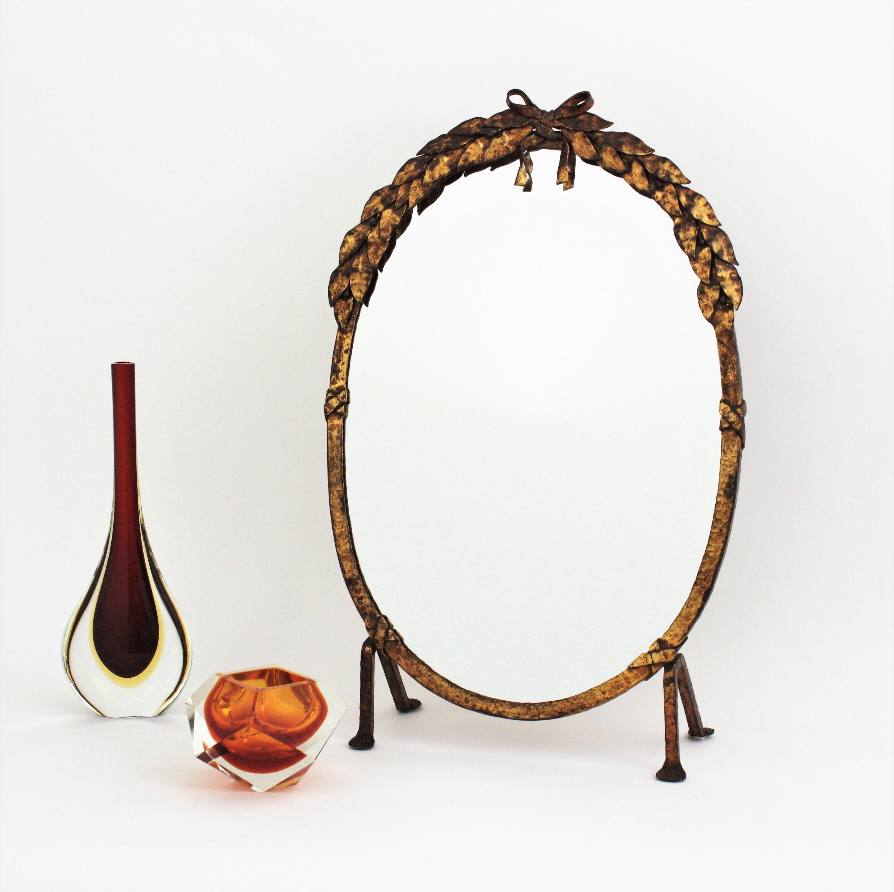 Superbe table / miroir de courtoisie ou miroir sur pied ovale en fer forgé à la main avec des détails de feuillage, France, années 1940.
Ce joli miroir ovale est entièrement réalisé à la main en fer. Il se dresse sur quatre pieds en fer. Le cadre