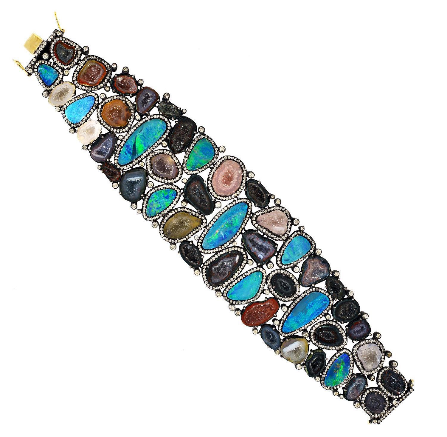 A stunning bracelet handmade in 18K gold and sterling silver. It is set in 25.221 carats of opal doublets, geodes and 7.477 carats diamonds. Pair this with your favorite evening dress for a red carpet look. Clasp Closure

Composition
Size-190