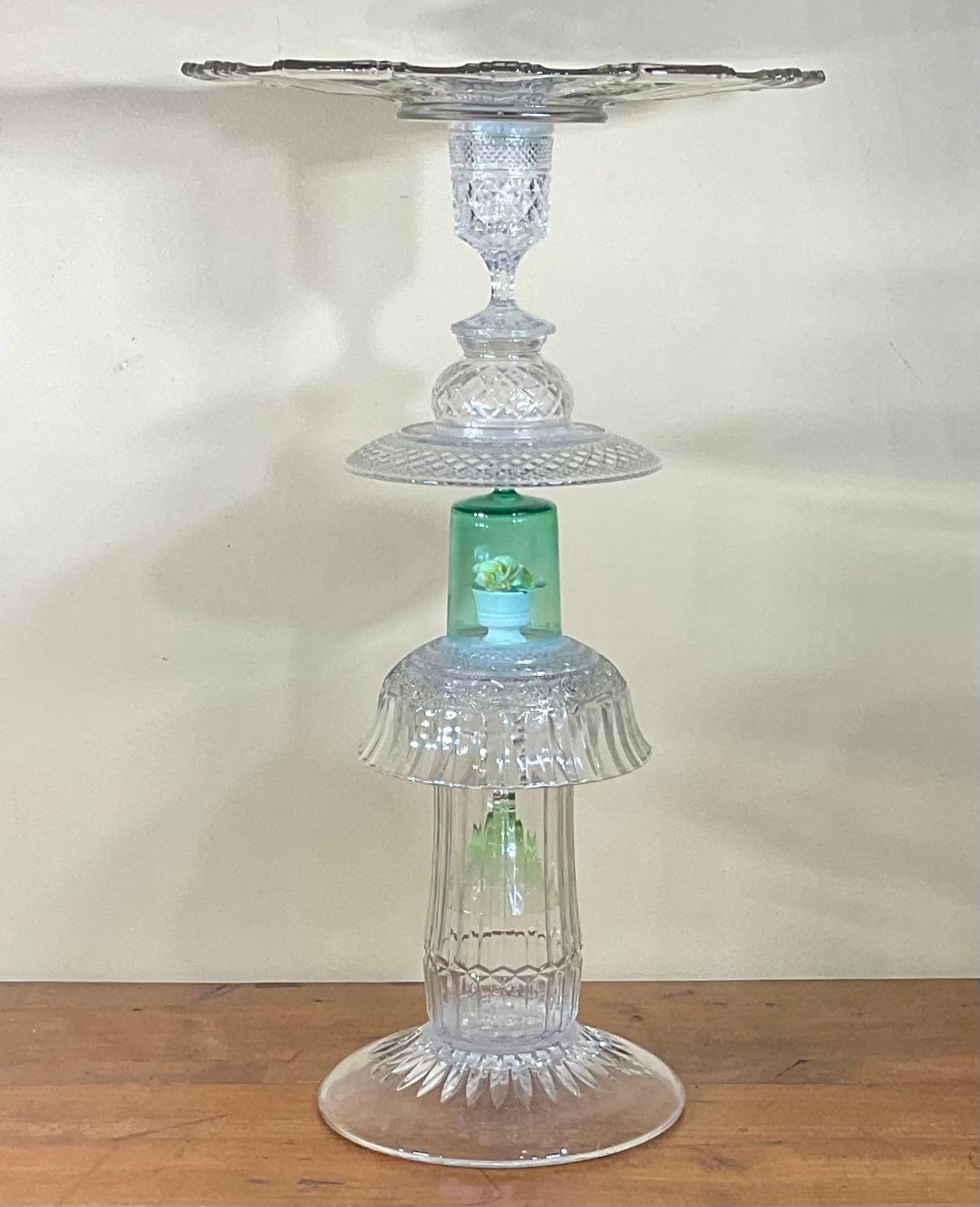 Glass table artistically made of combination of vintage art glass ,cut glass ,press glass and porcelain flower , put together to be beautiful table for use in display or use in any fancy occasion.