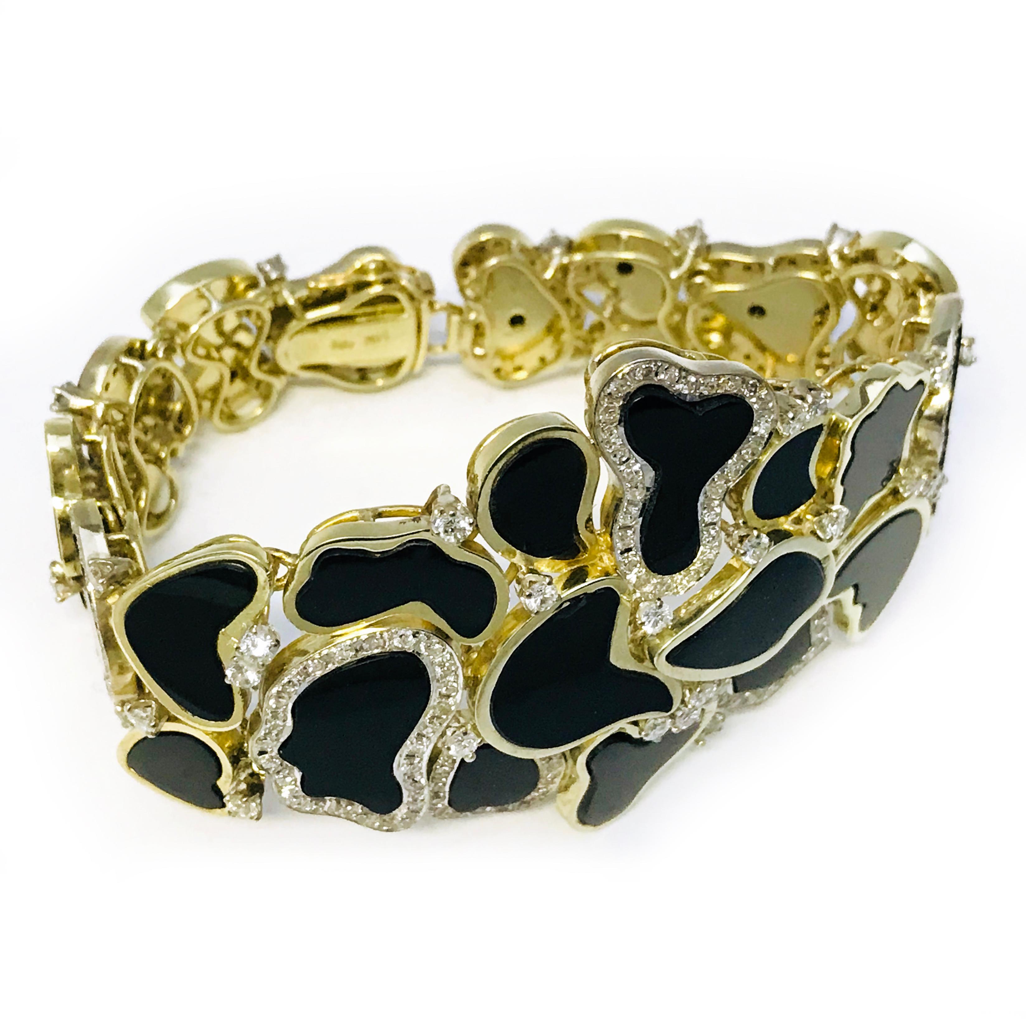 Gorgeous one-of-a-kind 14 Karat Yellow Gold Free Form, Onyx, and Diamond Bracelet. The bracelet consists of free-form shapes in 14k Yellow Gold with Onyx, multiple shapes contain a Diamond bezel in 14k White Gold. The total length of the bracelet is