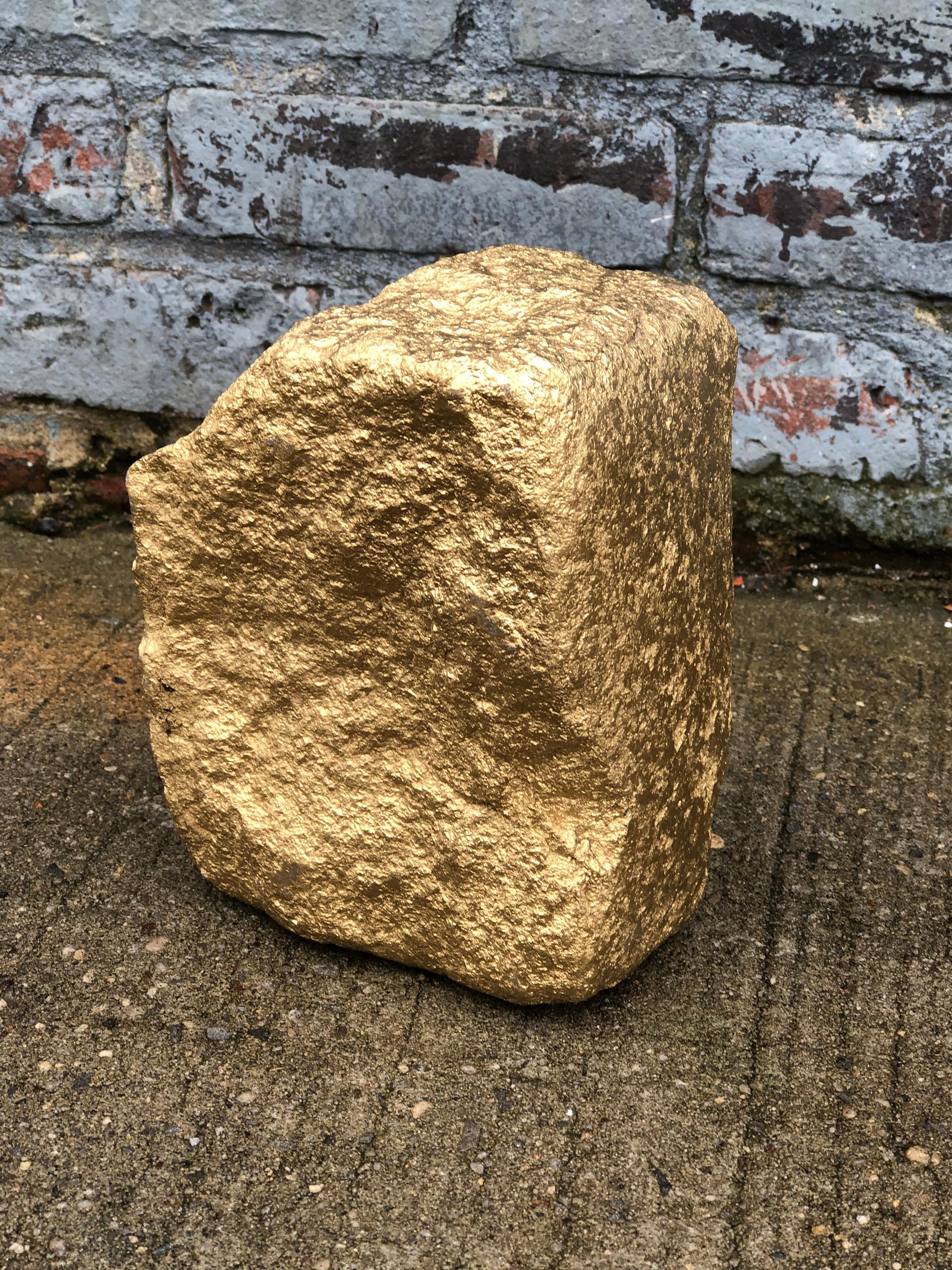 One of a kind and unique door stopper. Shiny gold in Belgian block style stone. Very heavy and perfect stylish way to keep the door ajar.
