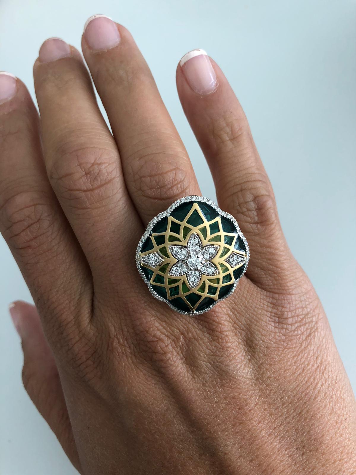 Italian 18K white and yellow gold floral ring featuring a diamond cluster and diamond outline weighing 0.73 Carats with shades of light to dark green enamel. Color F-G Clarity SI
A real eye catcher.
Ring is sizeable 