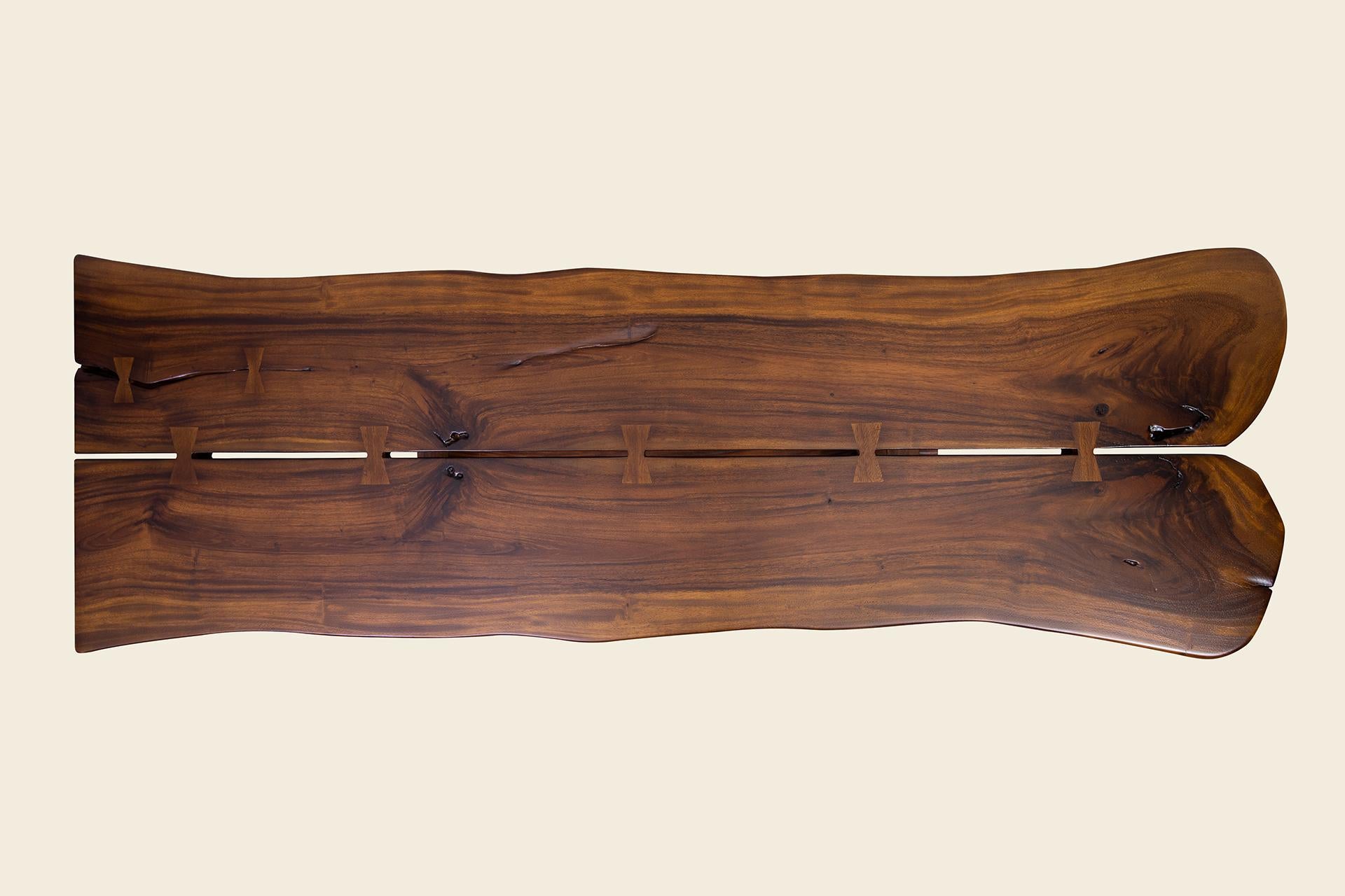 Add style and elegance to your space with this hand-crafted, Nakashima-Inspired console table. Two beautiful live-edge pieces of wood are expertly matched at the center and then attached with inlaid butterflies. The base is all crafted in the