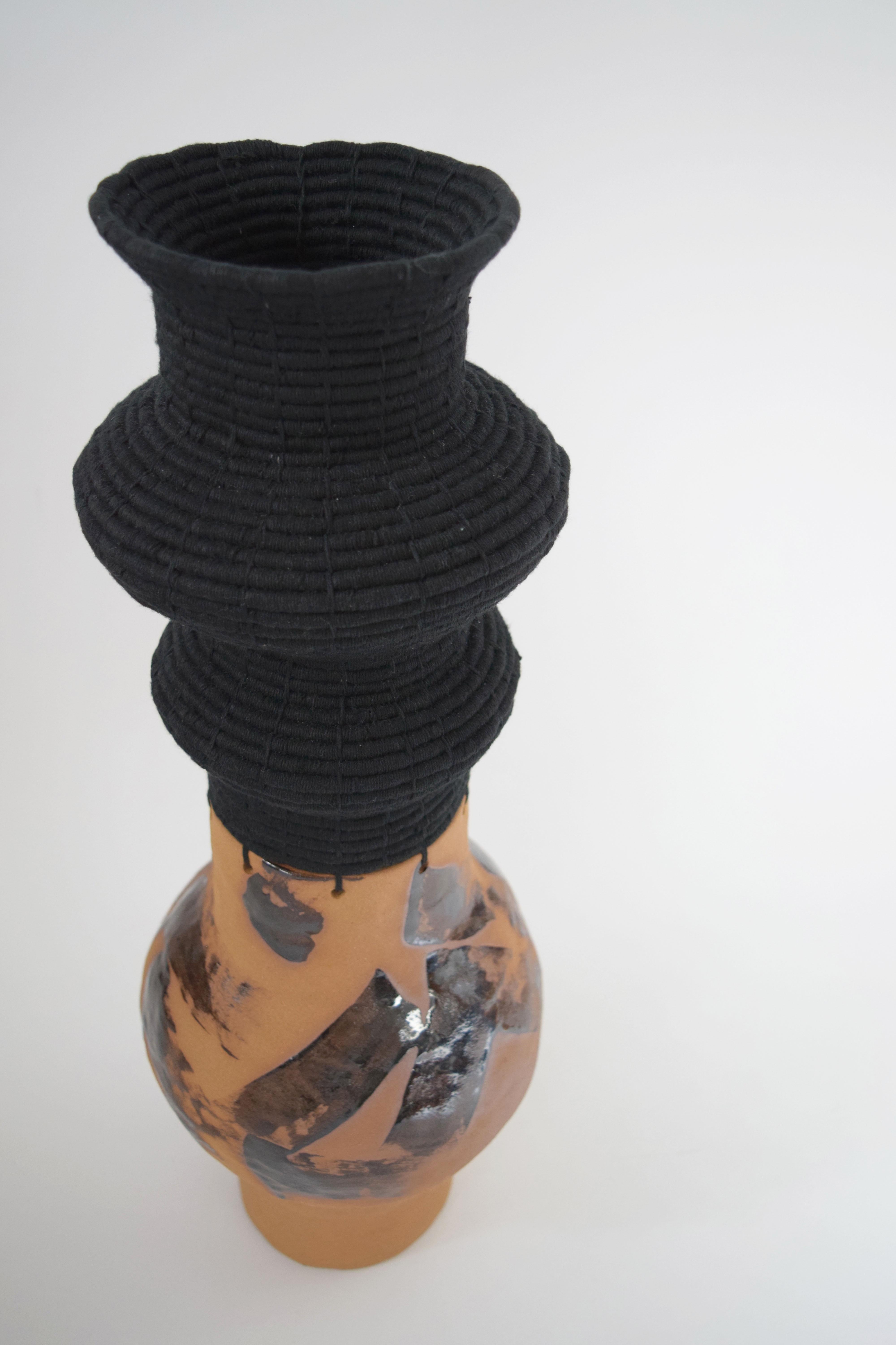 One of a kind vessel #632 by Karen Gayle Tinney

One of a kind vessel with hand formed ceramic base. The ceramic base is left unglazed, and painted with brushstrokes of black glaze with variation in density of color ranging from brown to black.