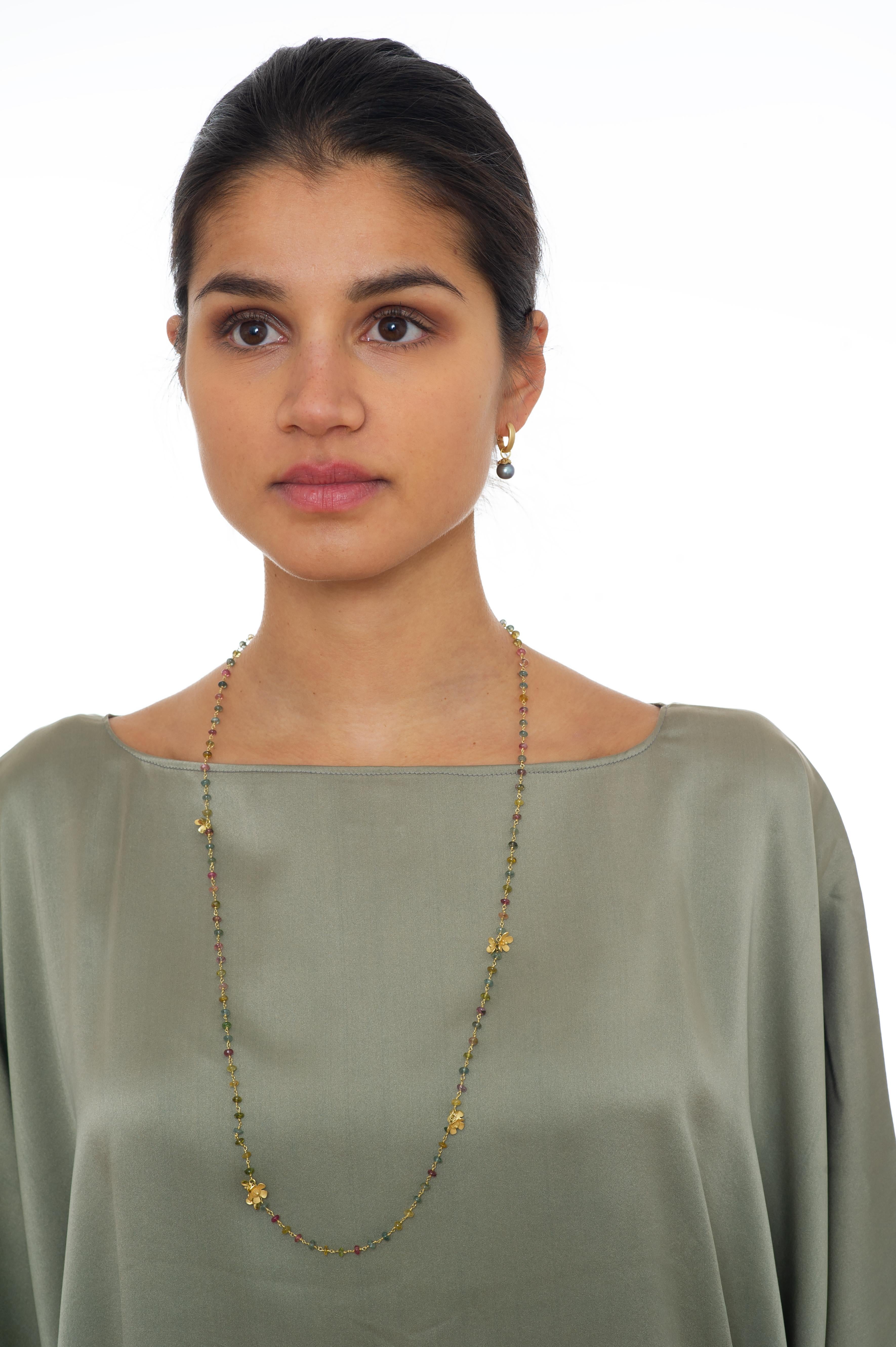 This handcrafted one-of-a-kind necklace is the epitome of elegance. Crystal clear multi-colour tourmaline beads in soft pastel are wire-wrapped on 18k yellow gold wire interspaced with hand-made delicate little gold flowers. Wear this light-weight