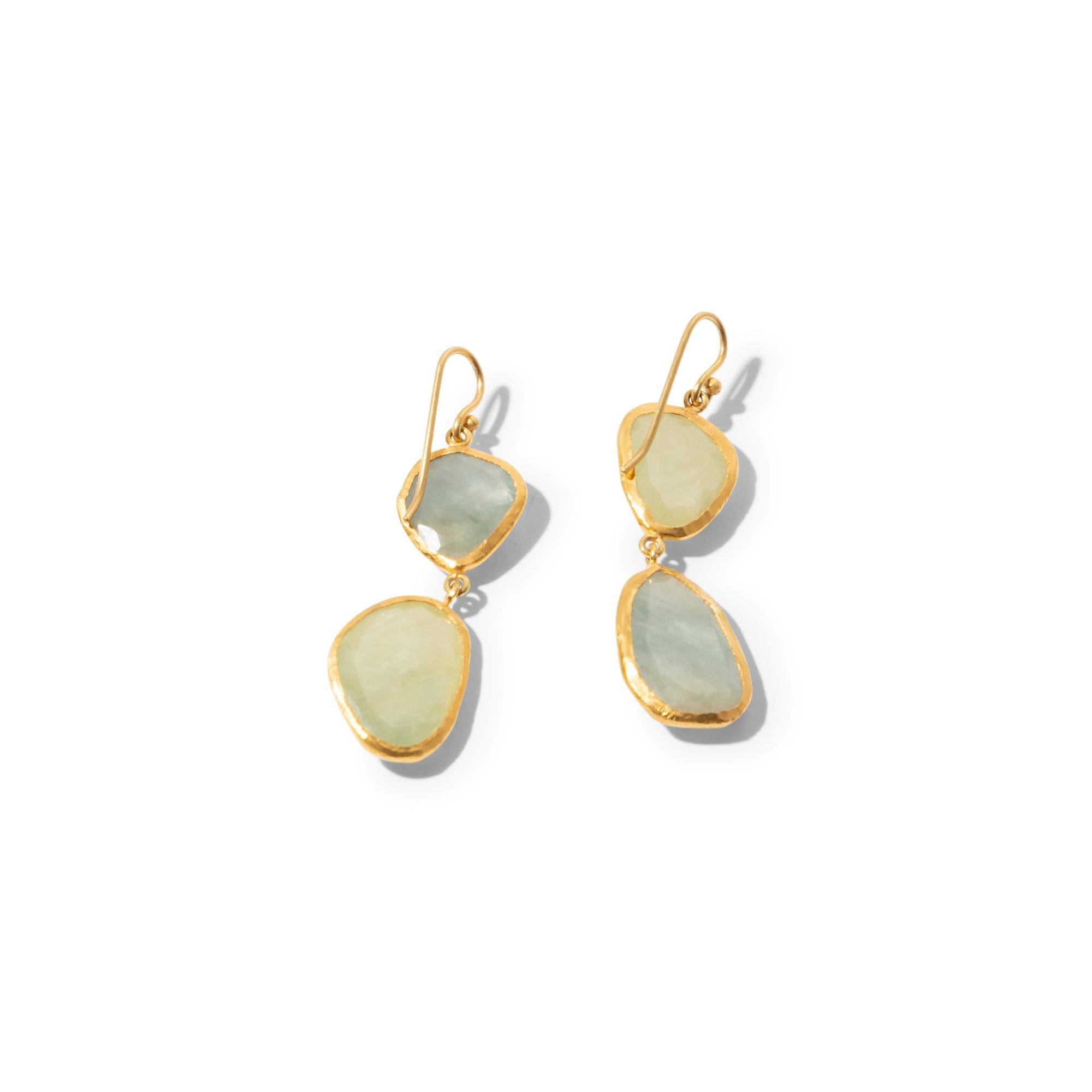This pair of hand-made earrings oozes understated elegance. The soft green hues and the modern cut of the gemstones makes it a wearable piece which transitions easily from day to night. The large, natural and untreated green sapphires (total weight