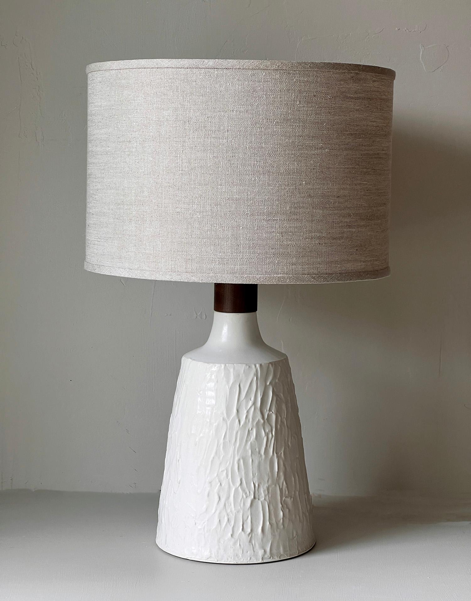 This one of a kind porcelain and walnut table lamp combines the warmth of wood with cool porcelain. Created as a collaboration between husband and wife creative partners, Daniel Oates and Dana Brandwein. The base was thrown by hand on the potter's