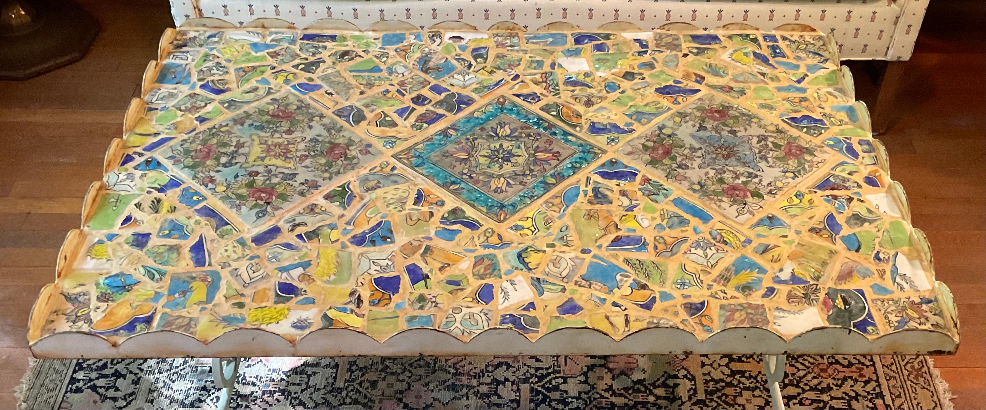 Exceptional coffee table made of iron, three beautiful hand painted Persian tiles 
surrounded by beautiful mosaic of broken Persian tiles. Decorated steel top frame help the table to be very functional 
The tile top table is sealed with water