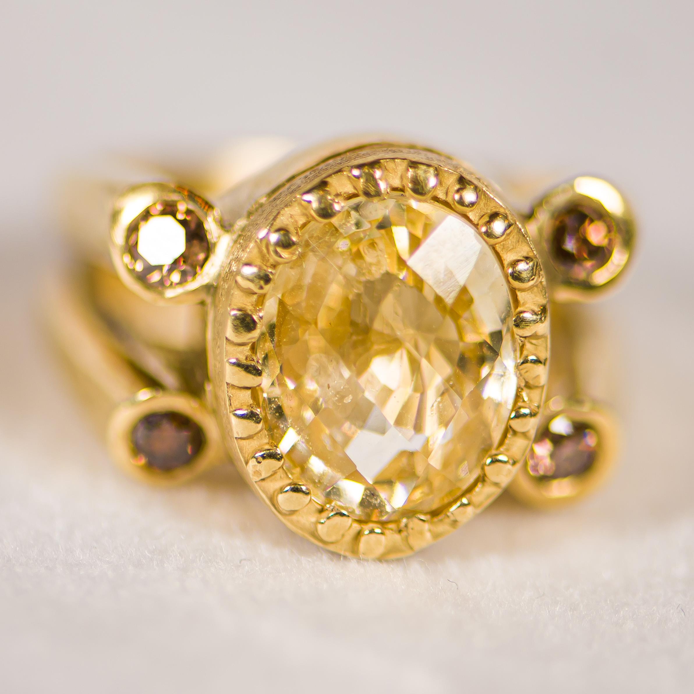 Another 1 of a kind piece by Julia Boss, who's a Palm Beach designer. Her pieces are only available at select Neiman Marcus locations.  We present this unique 6 carat faceted oval yellow sapphire boasting her signature U shape burnished accent