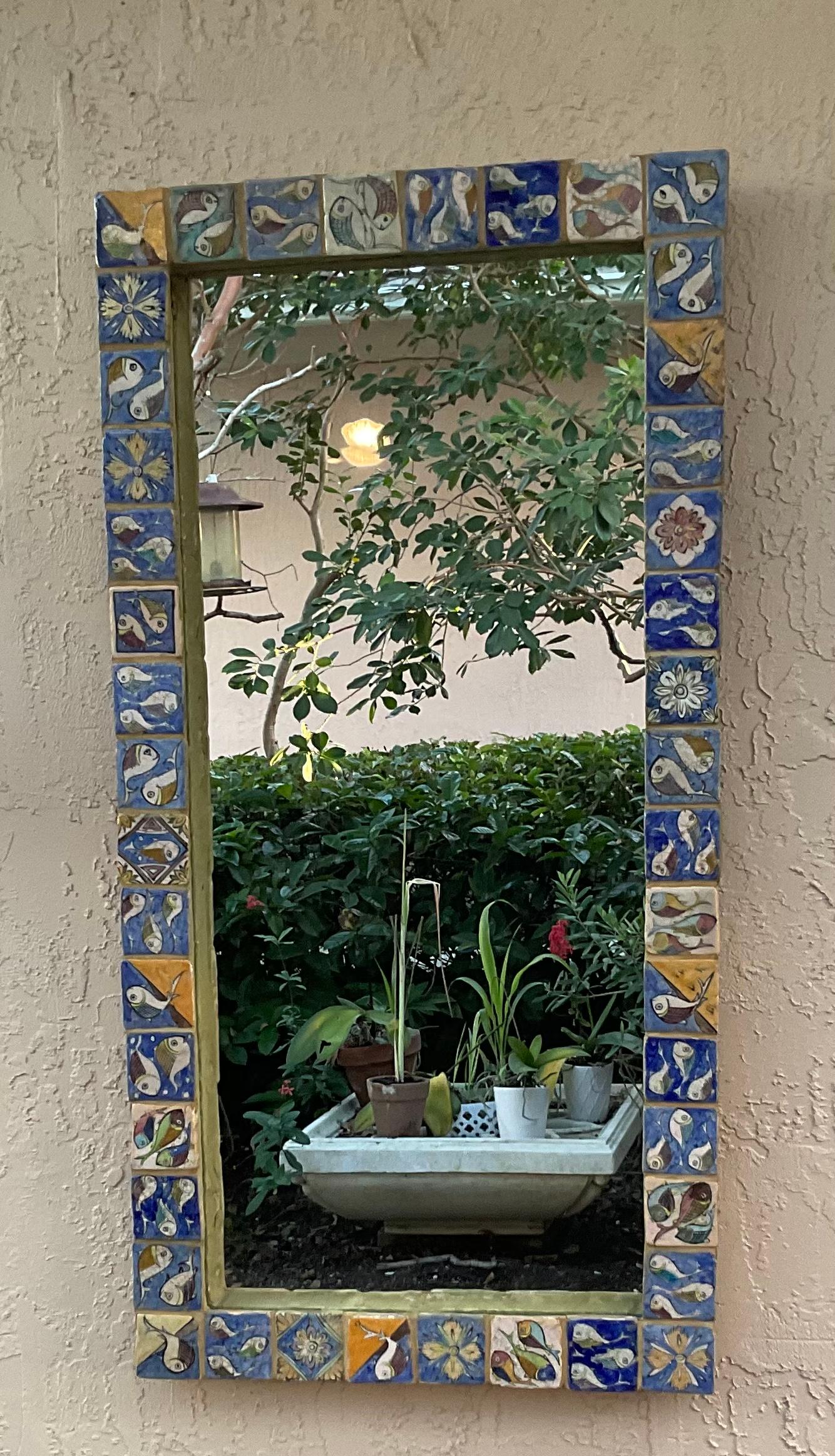 Beautiful large mirror made of hand-painted and glazed ceramic tiles, with exceptional motifs of vines flowers fish and geometric motifs great object of art for wall display.
In order to save on shipping cost the mirror will be shipped in two boxes