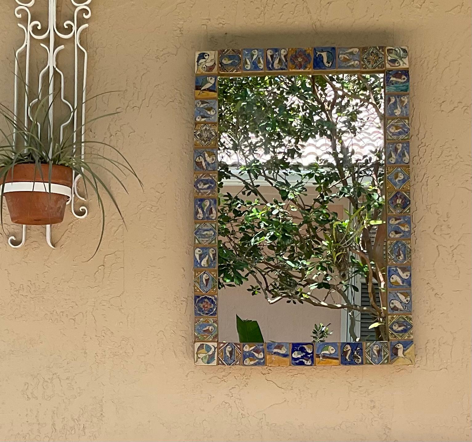 Beautiful large mirror made of hand-painted and glazed ceramic tiles, with exceptional motifs of vines flowers fish and geometric motifs great object of art for wall display.
Total weight : approx 32 pound.
Glass mirror size only :20”x 32.75.
 