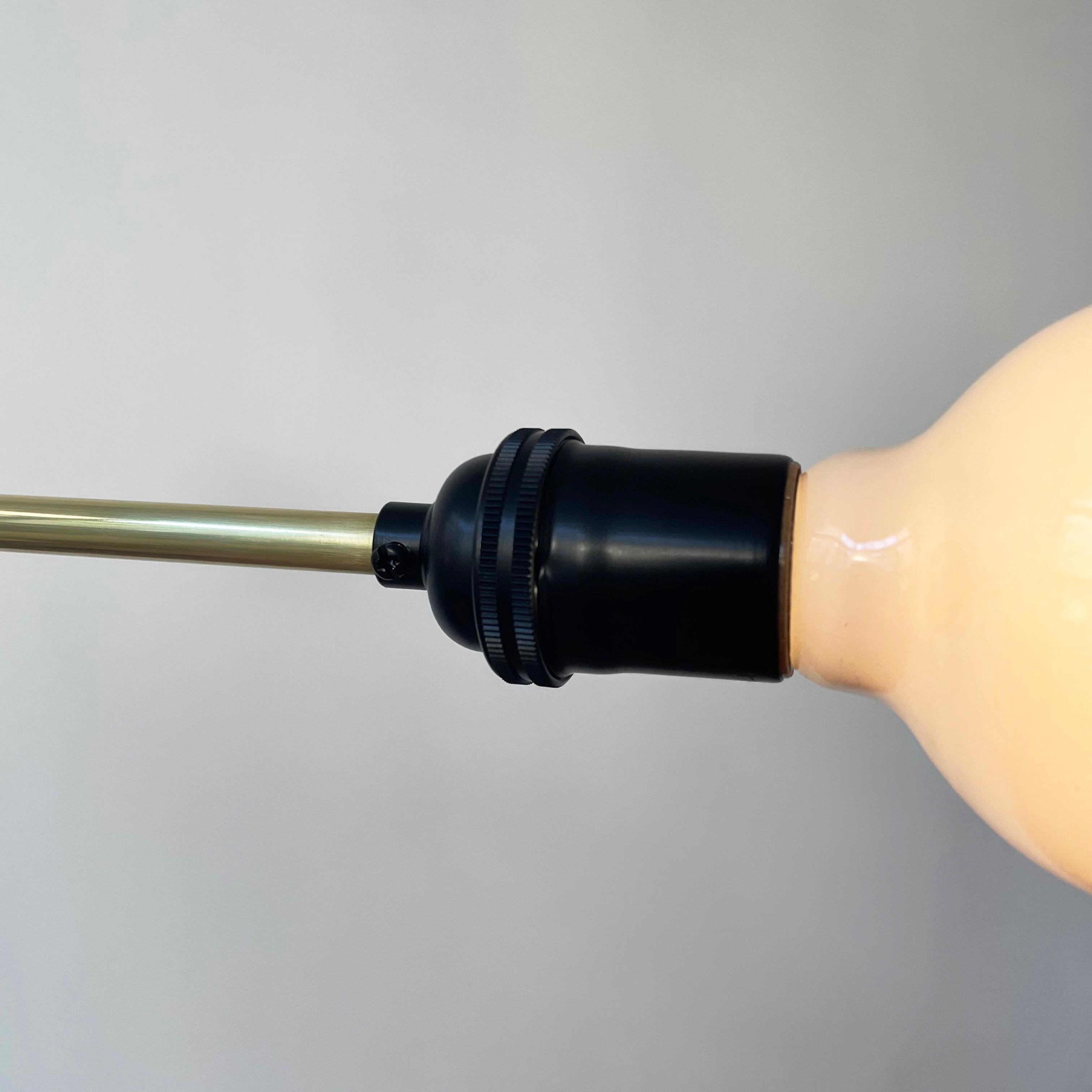 This listing is for 1x one of a kind hardwired industrial chandelier in black & brass. The fixture has 3x E26 sockets (bulbs not included).

The brass components on this fixture are a raw brass, so you can let them tarnish over time or use a wax to