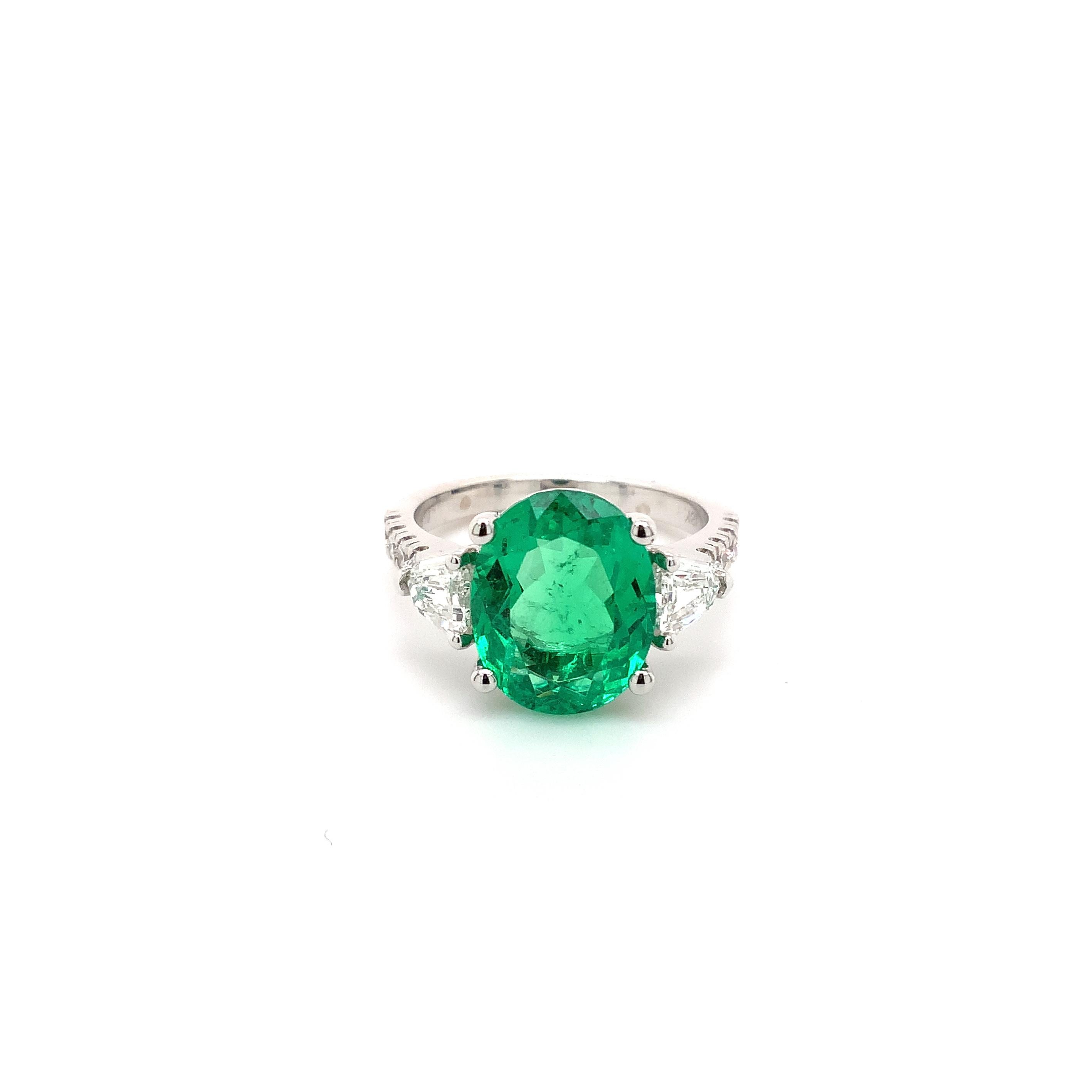 This One Of A Kind Natural Fine Colombian Emerald And Diamond Ring is Set in 18K White Gold 4 Prong Setting.
One Oval Mix Cut  Emerald Equal 3.60 cts tw. 12x9.5mm 
2 Bullet Shaped Step Cut Diamonds 0.60 cts
8  Round Brilliant Cut Diamonds 0.25