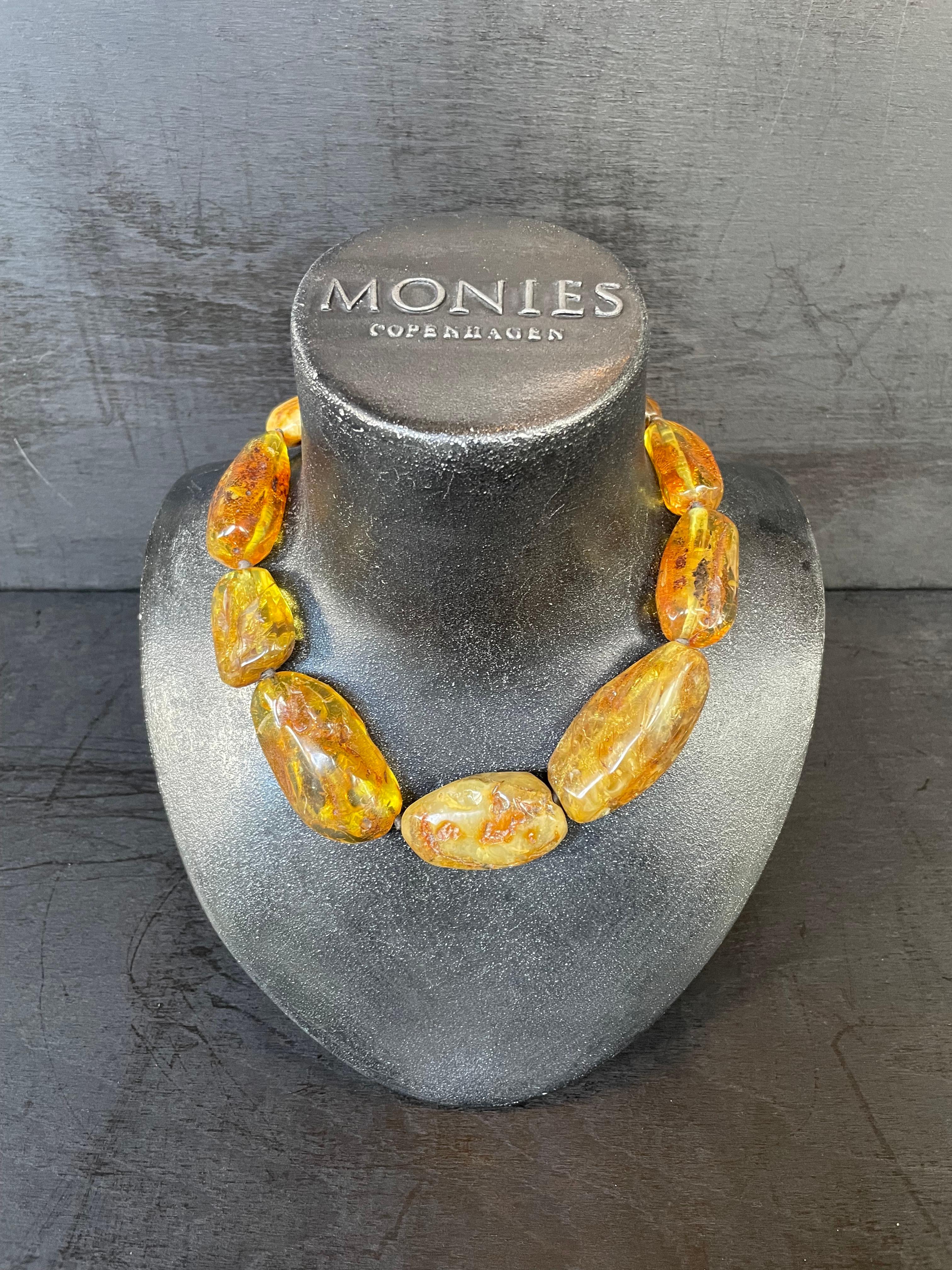 One-of-a-kind statement necklace from the Danish jewellery brand, Monies.
Made in Amber with a leather clasp.

Handcrafted in the Monies Atelier in Copenhagen.