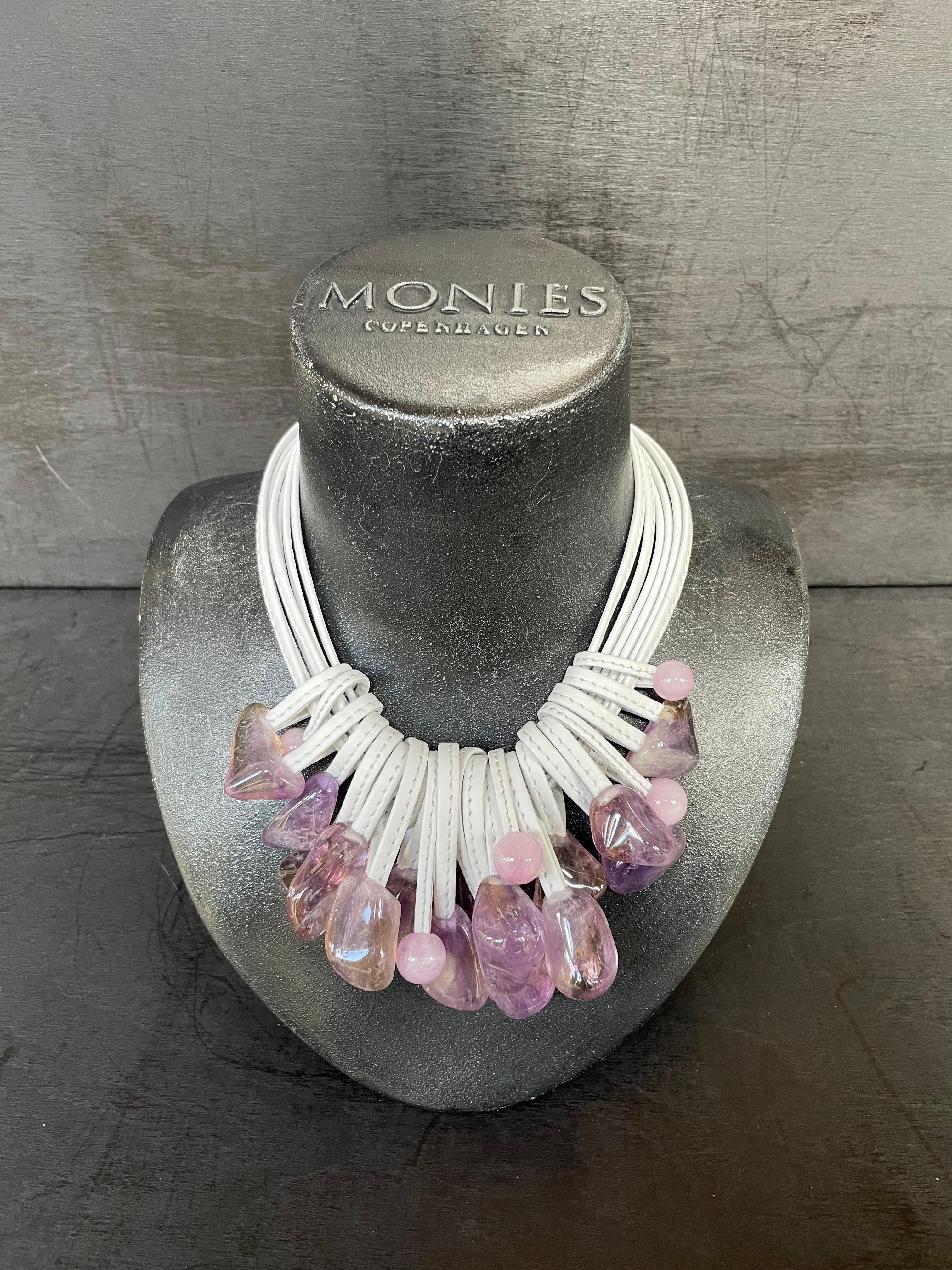 One-of-a-kind statement necklace from the Danish jewellery brand, Monies.
Made in Amethyst, Lavender Rose Quartz and Leather with a leather clasp.

Handcrafted in the Monies Atelier in Copenhagen.
