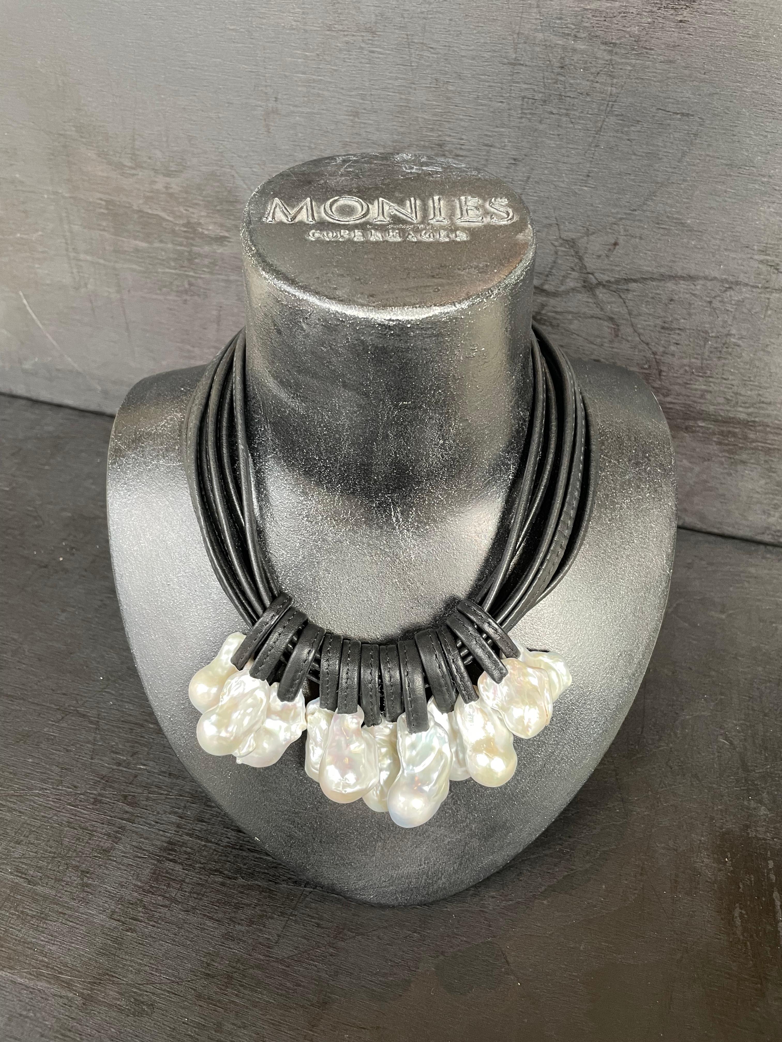 One-of-a-kind statement necklace from the Danish jewellery brand, Monies. 
Made in baroque pearls, leather and ebony, with a leather clasp. 

Handcrafted in the Monies Atelier in Copenhagen.