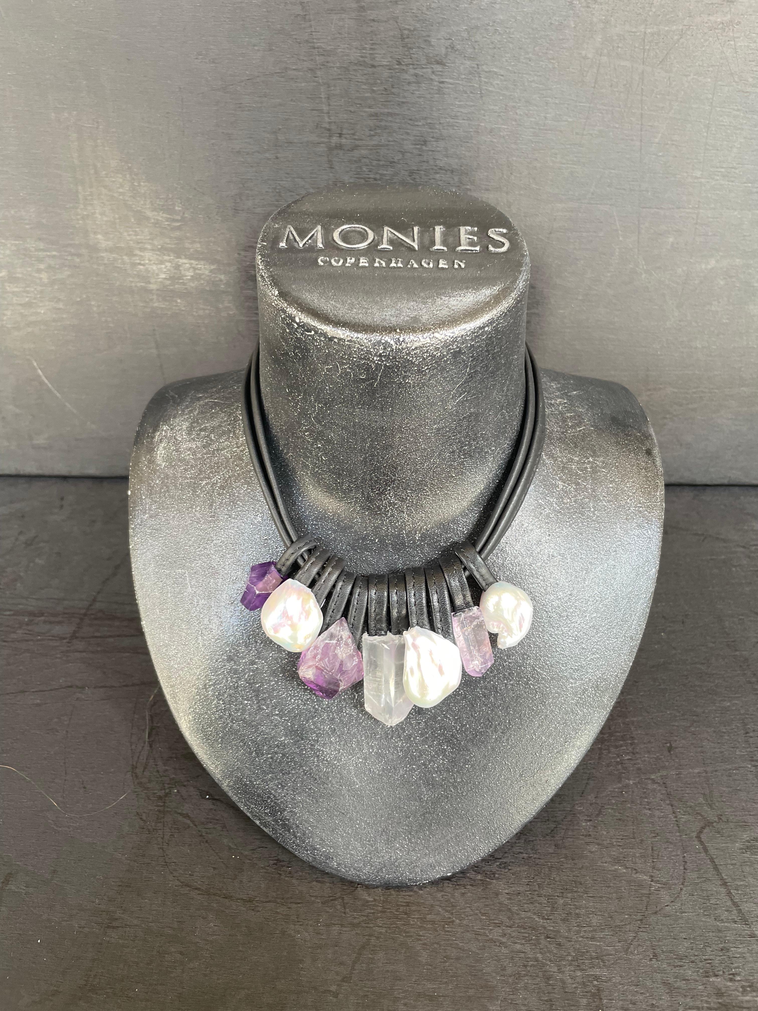 One-of-a-kind statement necklace from the Danish jewellery brand, Monies.
Made in Amethyst, Baroque Pearl, Mountain Crystal and Leather with a leather clasp.

Handcrafted in the Monies Atelier in Copenhagen.