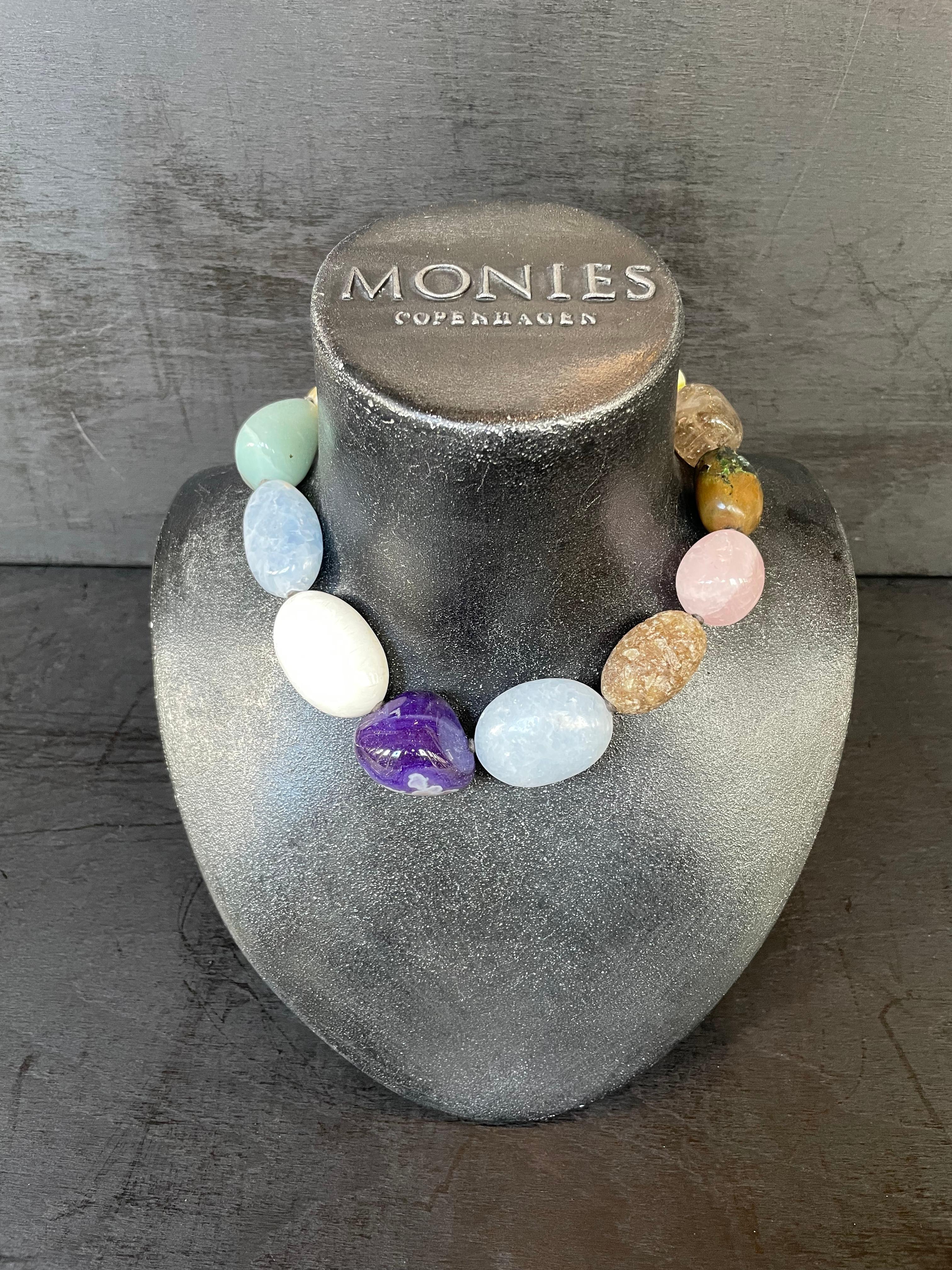 One-of-a-kind statement necklace from the Danish jewellery brand, Monies.
Made in Amethyst, Rose Quartz, Dolomite, Chalcedony and Agate with a leather clasp.

Handcrafted in the Monies Atelier in Copenhagen.