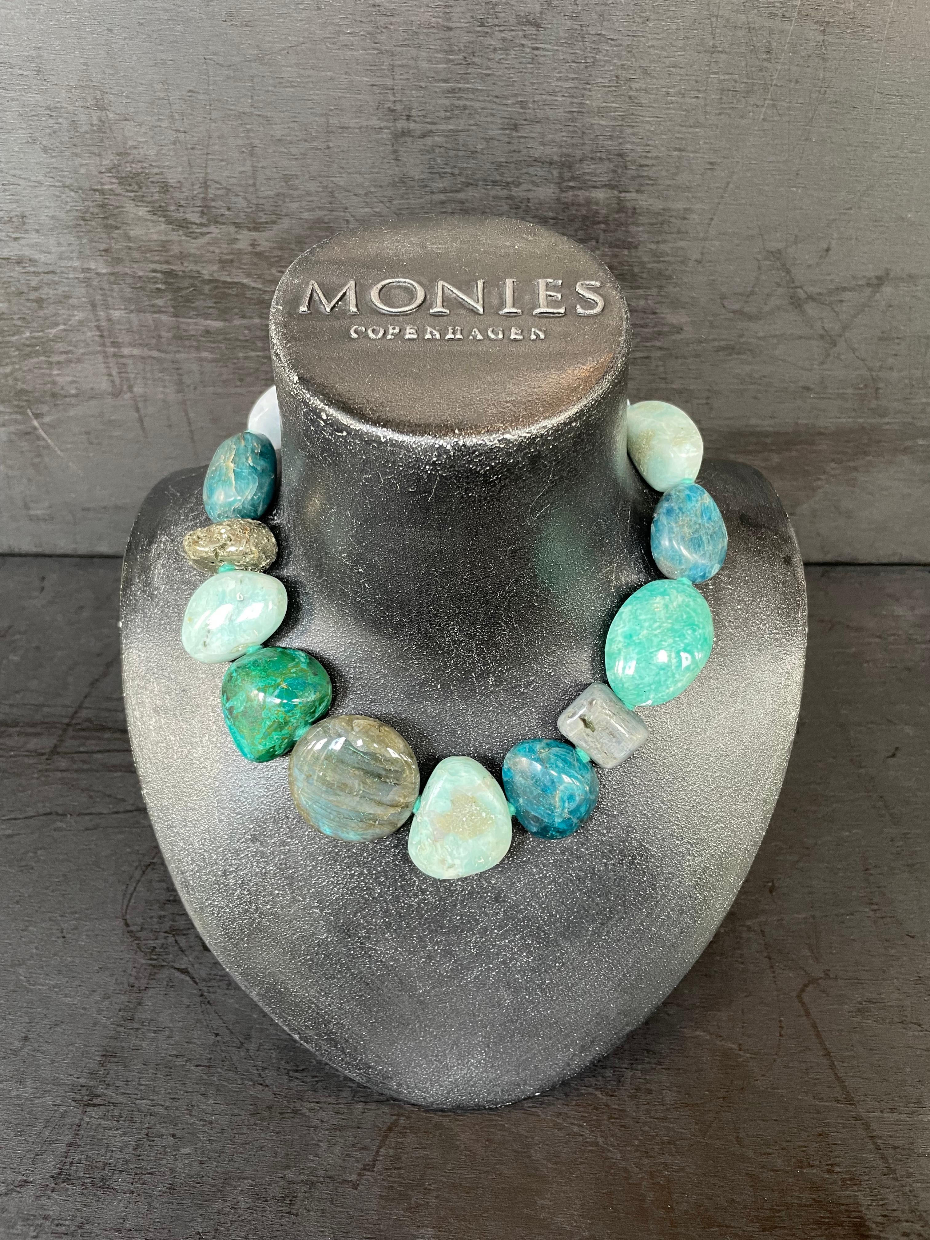 One-of-a-kind statement necklace from the Danish jewellery brand, Monies.
Made in Chalcedony, Apatite, Pyrite, Chrysocolla and Labradorite with a leather clasp.

Handcrafted in the Monies Atelier in Copenhagen.