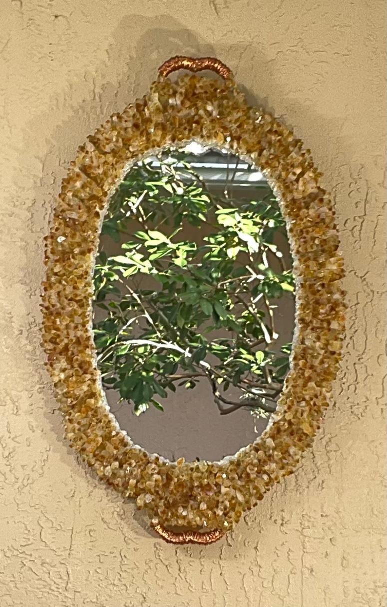 Exceptional wall mirror made of copper frame all artistically embedded with fine beautiful citrine crystal stone and points, all around oval shape, To make one of a kind beautiful object of art for wall display.
Actual mirror Size is : 21”.5 x 14”.