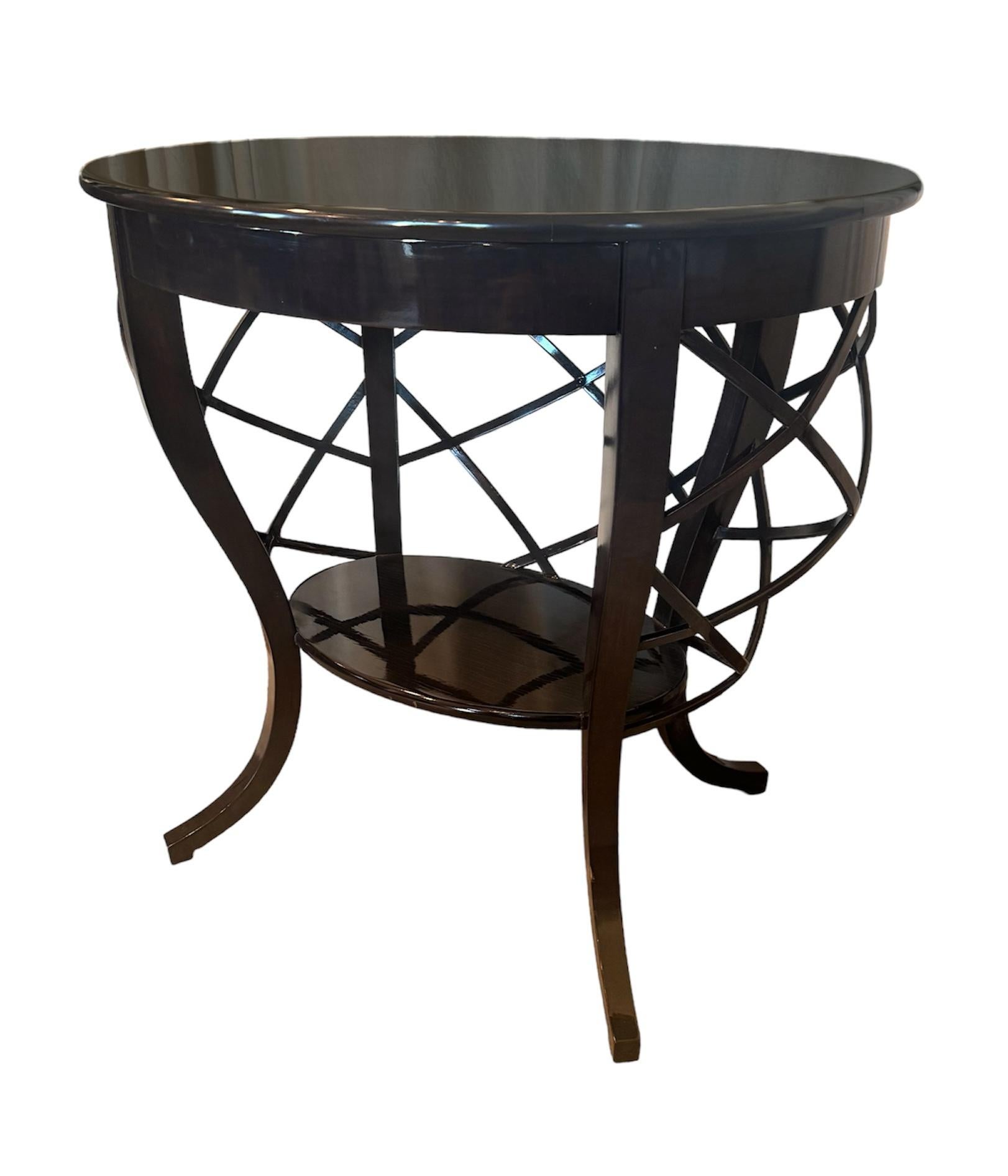 Elevate your living space with this one-of-a-kind oval side table, showcasing a striking ebonized and lacquered finish that exudes sophistication. The dark hue is complemented by a high gloss sheen, making it a standout piece in any room. The table