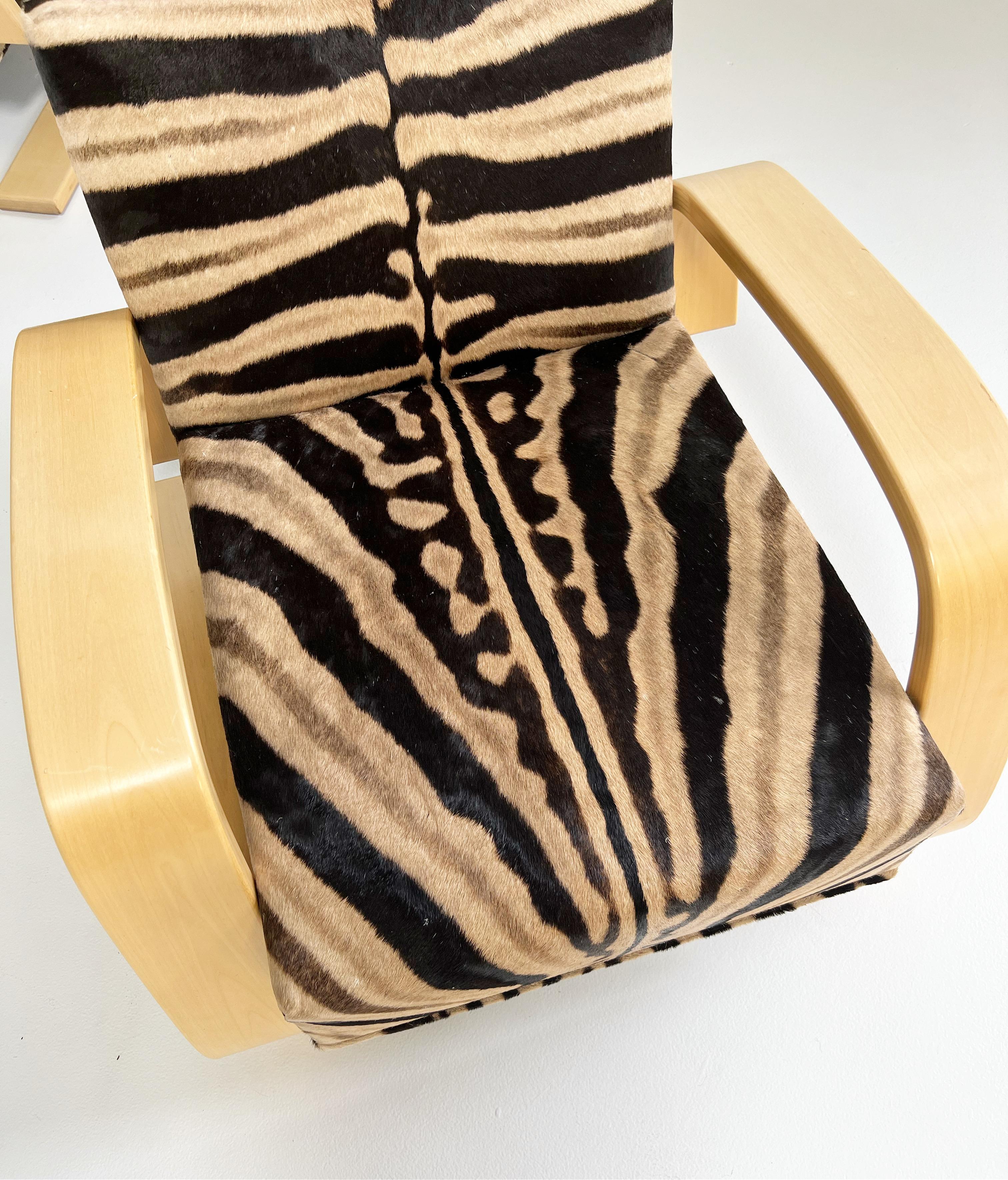 A beautiful pair of Tank armchairs, masterfully restored in zebra hide. The Armchair 400 or 