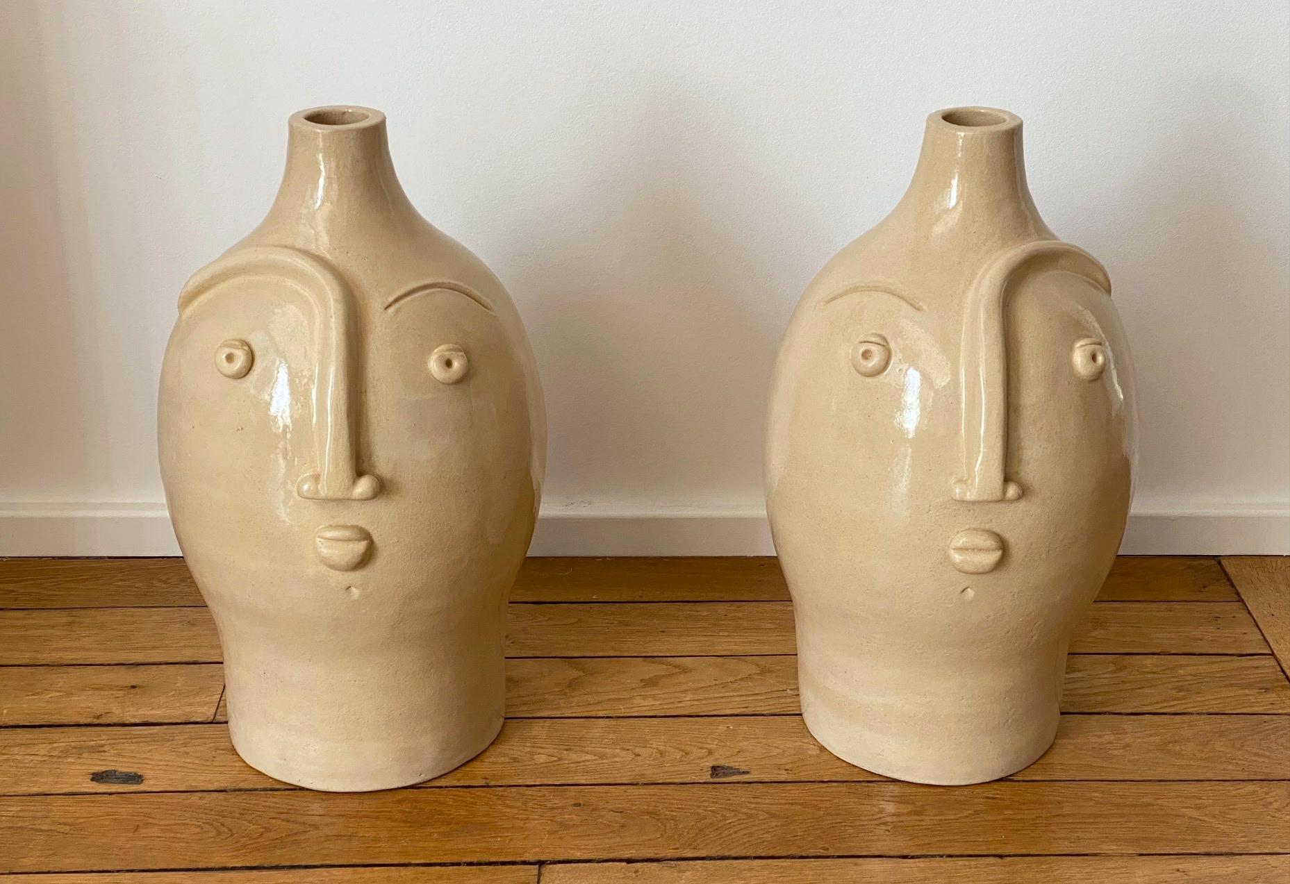 Hand-sculpted ceramic lamp bases or sculptures with stylized faces, stoneware with shiny beige enamel 
One of a kind handmade pieces signed by the French ceramicists Dalo, 2021
The height dimension is for the ceramic sculpture solely (H 47