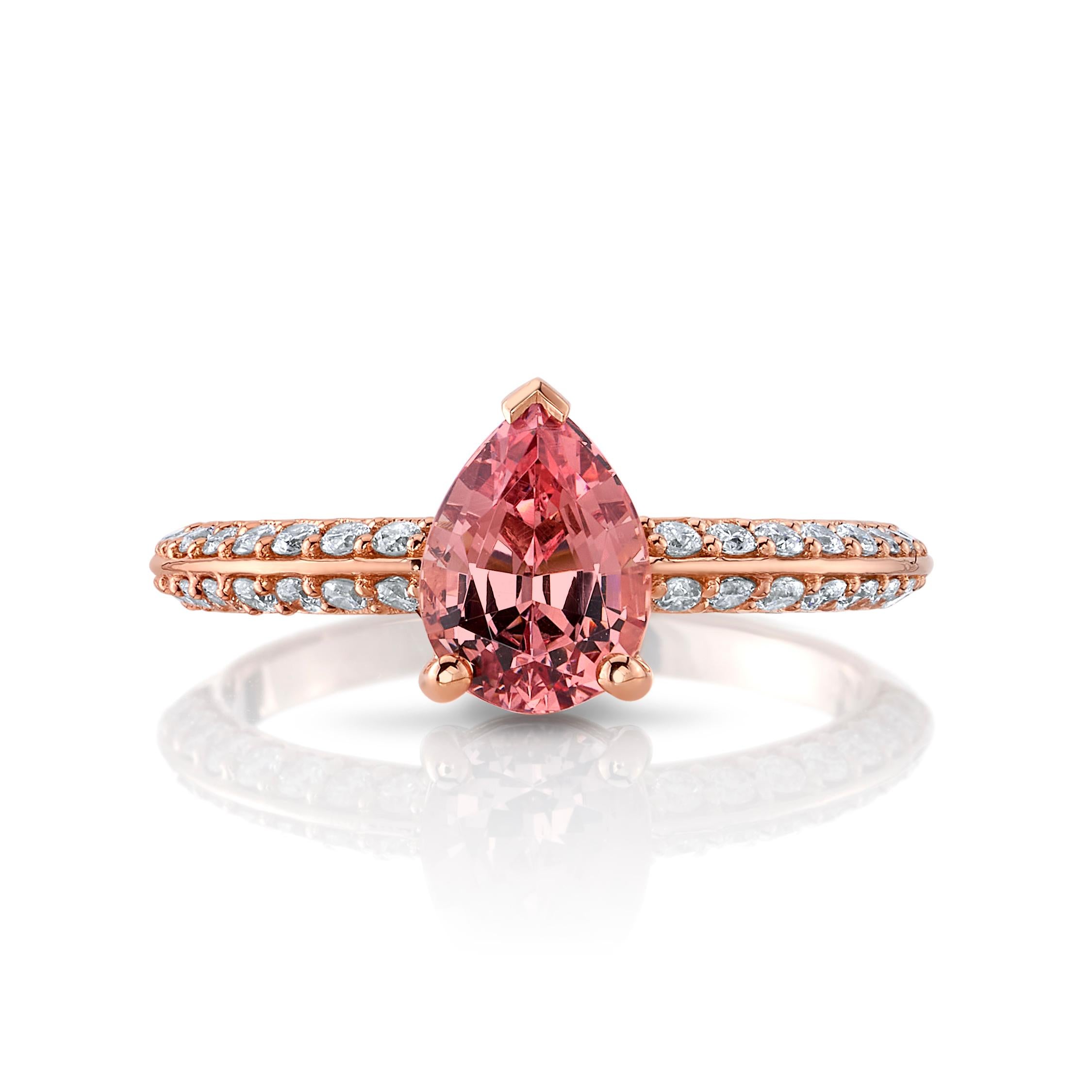 A beautiful 1.84 carats pear-shaped Malaya Garnet from Tanzania is complimented by diamonds totaling 0.35 carats set on both sides of an 18K rose gold knife-edge band. 

The designer fell in love with this Malaya Garnet as soon as she saw it