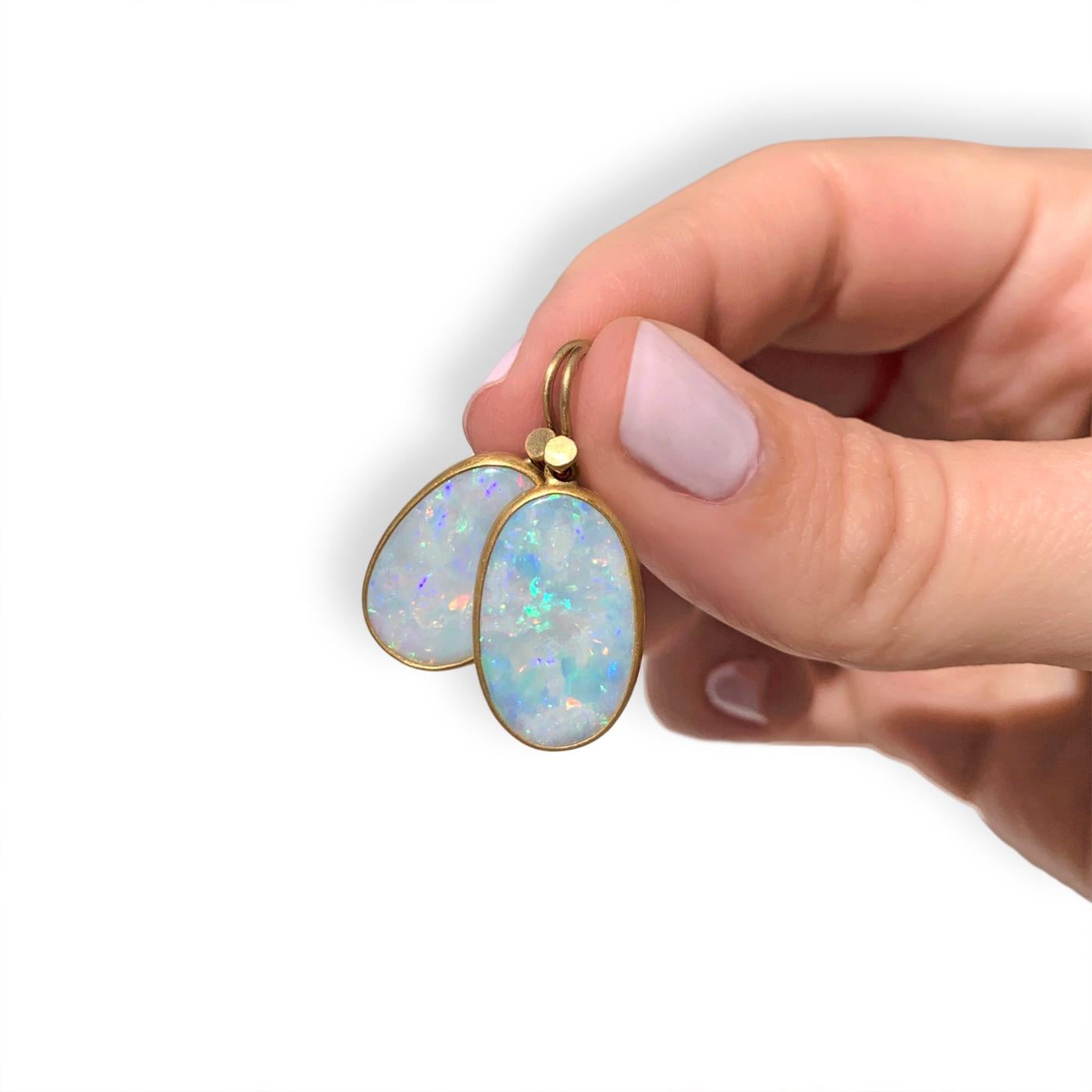 One of a Kind Drop Earrings by award-winning jewelry maker Lola Brooks, hand-fabricated in her signature-finished 22k yellow gold featuring a gorgeous matched pair of oval Australian opal drops, totaling 6.56 carats, each bezel-set and finished with