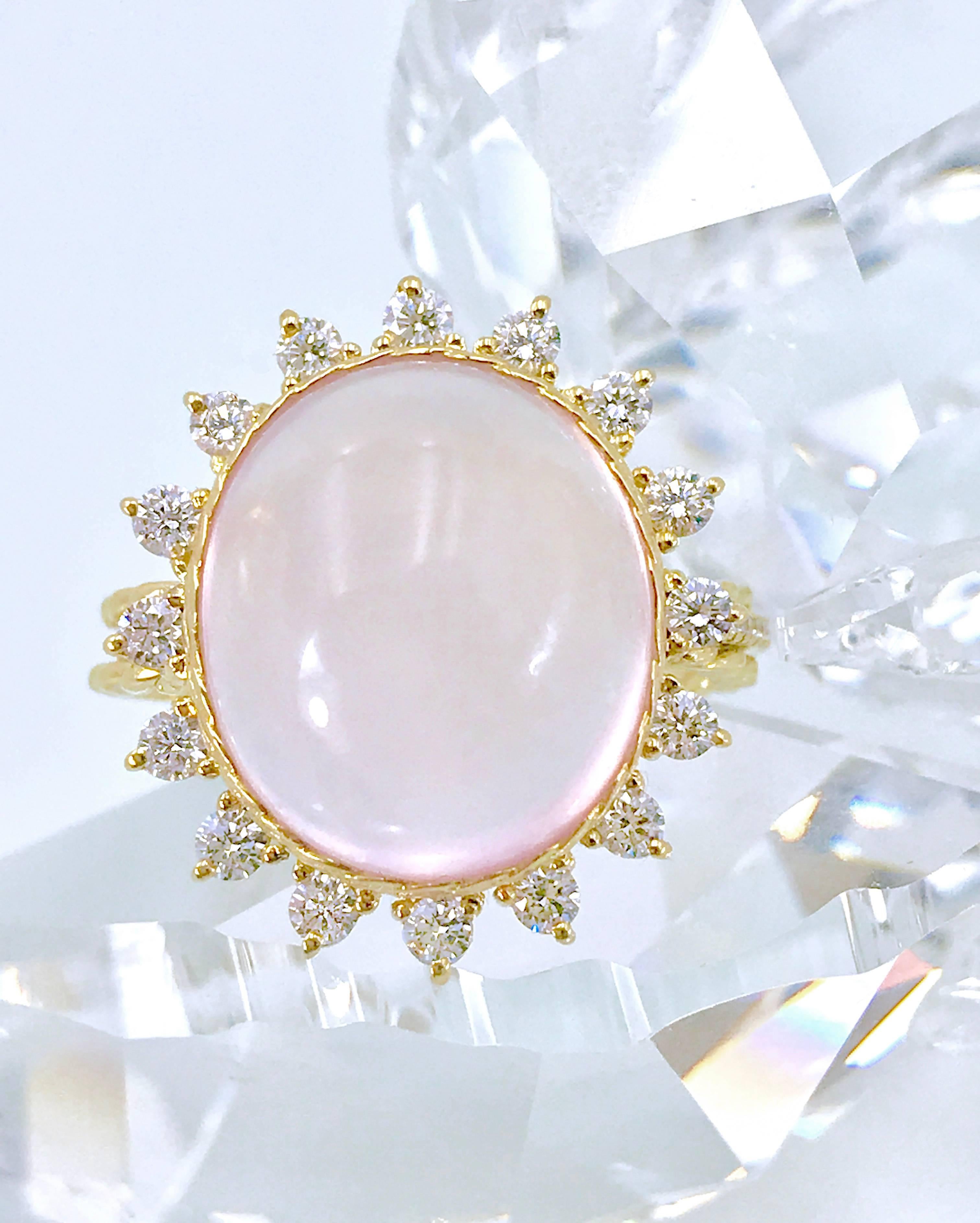 Charming 10.41 carat Rose Quartz Sun Burst Diamond Halo Cocktail Ring Set in 18K Yellow Gold in size 6 with 0.624 CTW Diamonds. It's in stock and ready to ship.

Rose quartz is a calming and reassuring crystal, and the color of soft pink has the