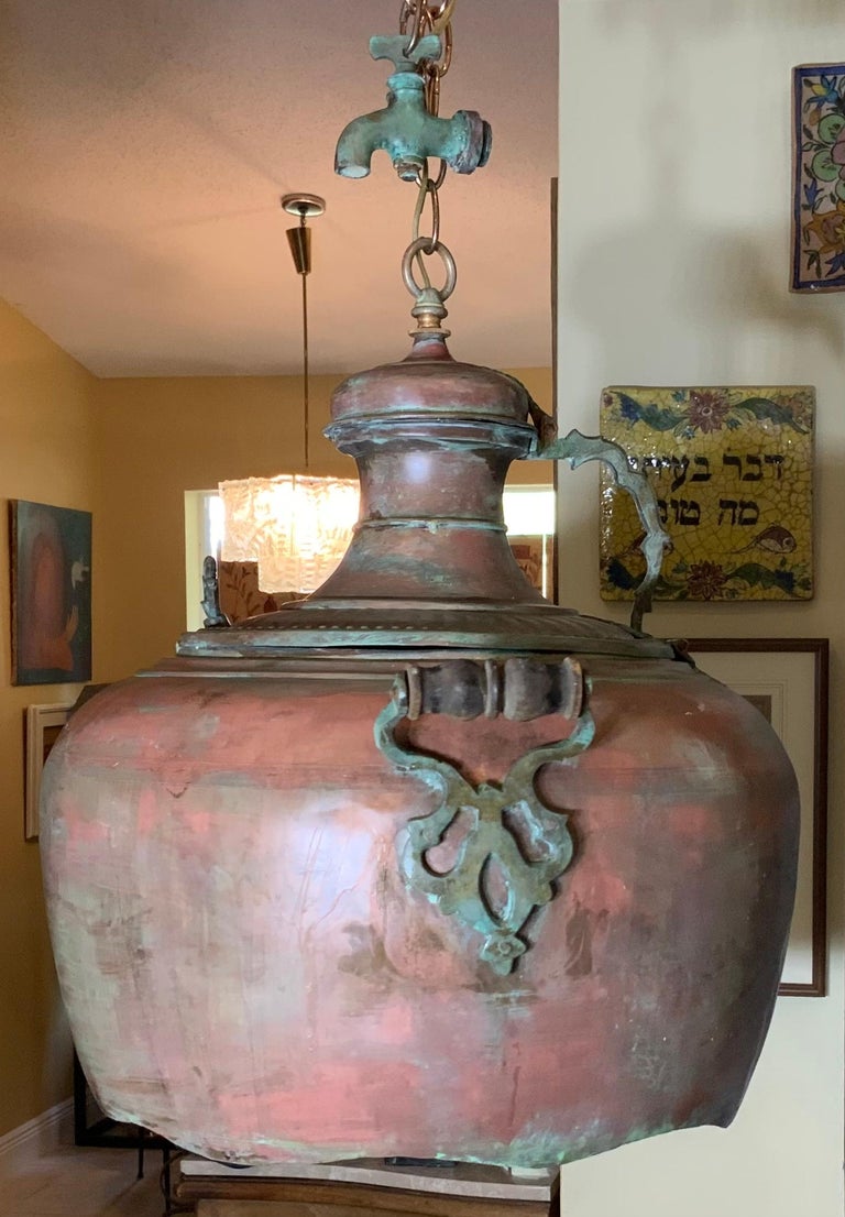 Funky hanging chandelier made of antique copper samovar , electrified with three 60/watt lights .
The original samovar spout is included ,and you can if you wish to hang it as extra decoration on the hanging chain .
Fine copper canopy included.
 