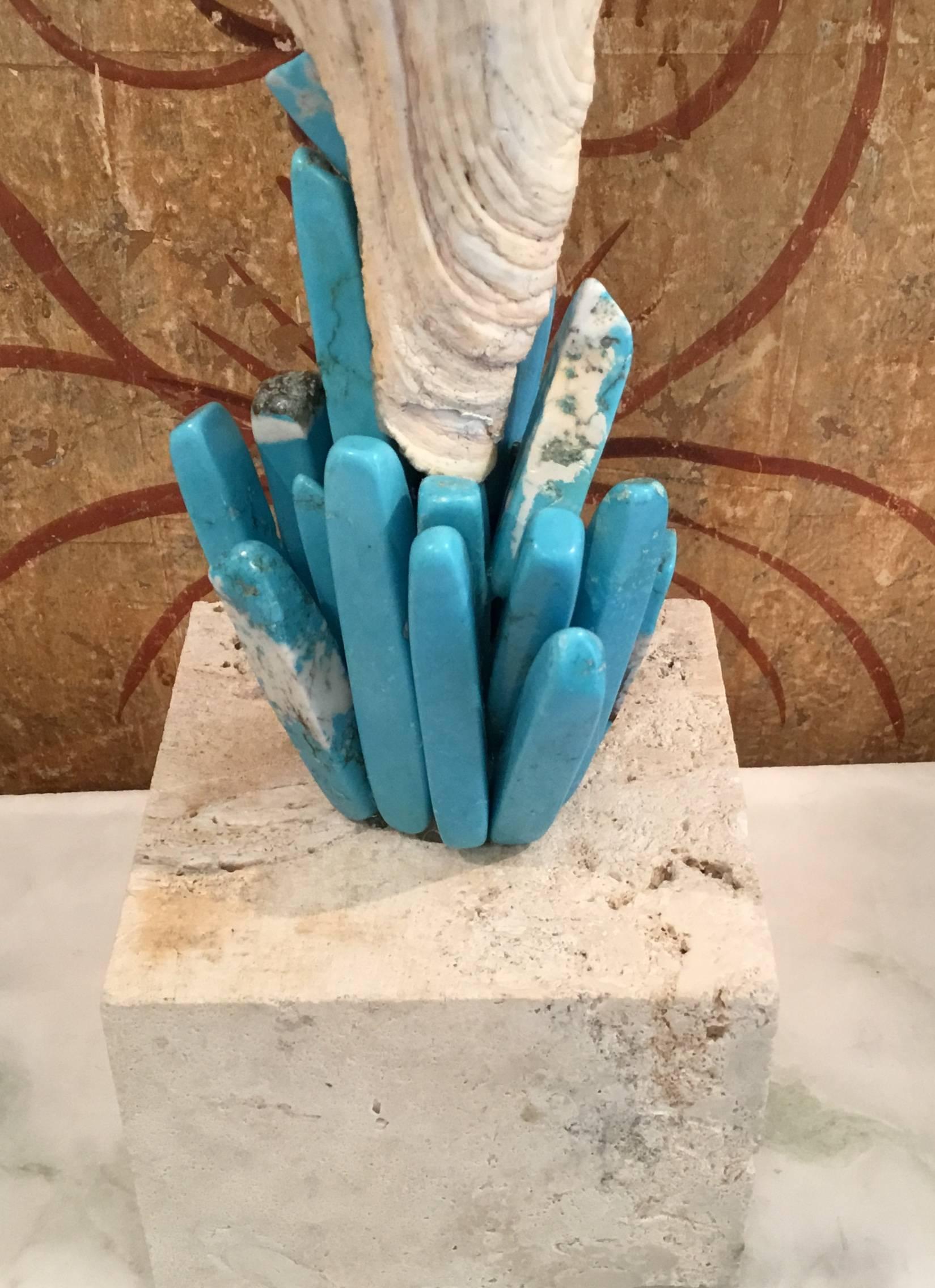Beautiful Atlantic trumpet seashell professionally mounted on genuine coral base, artistically hand embedded with fantastic turquoise stones all around, to make exceptional piece of art for display.