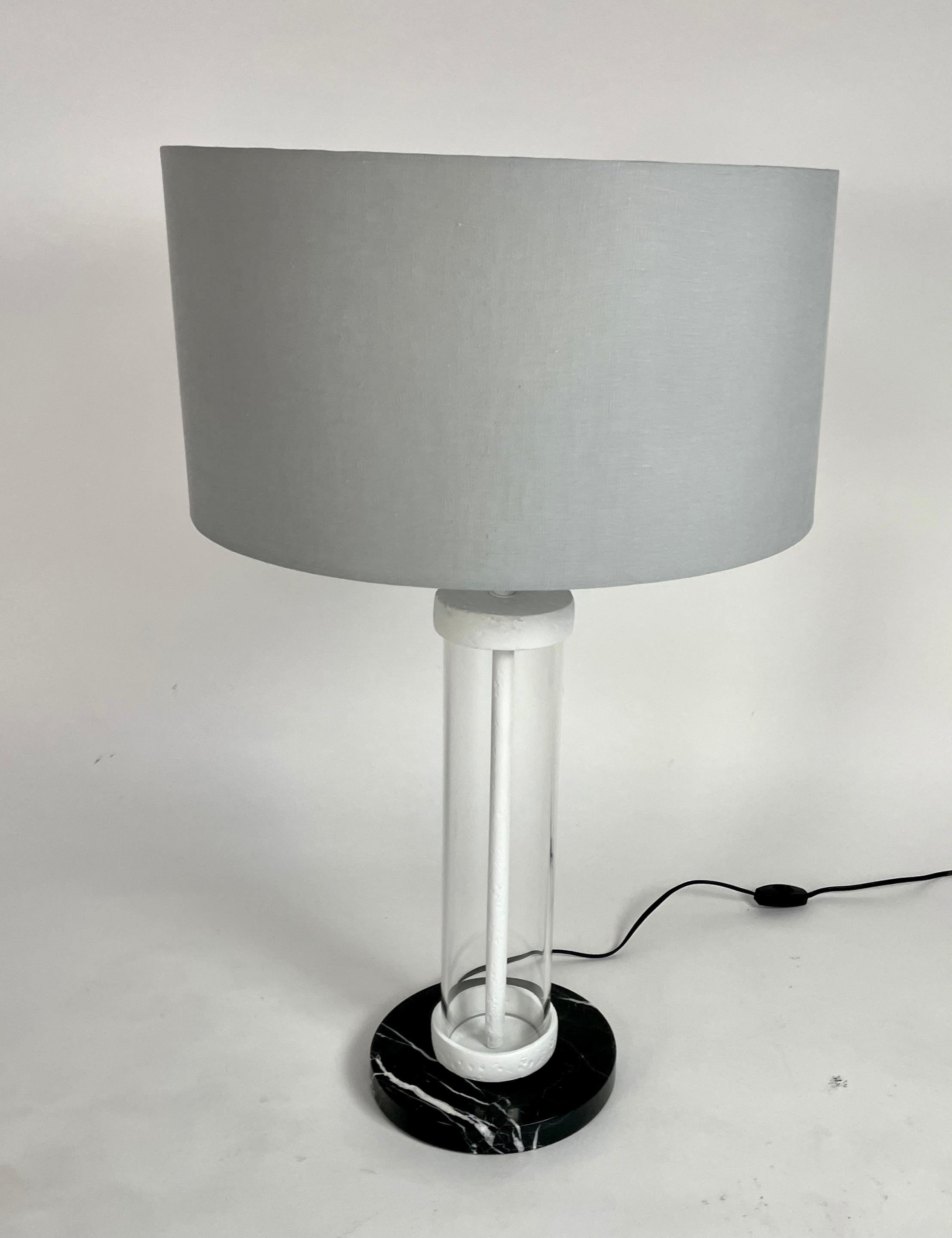 Medium scale table lamp created in our work shop with a glass tube, black marble base, and plaster of Paris elements. The grey cotton shade has a silver wash interior. It is a one of a kind lamp, not part of our Plaster lighting collection. Perfect