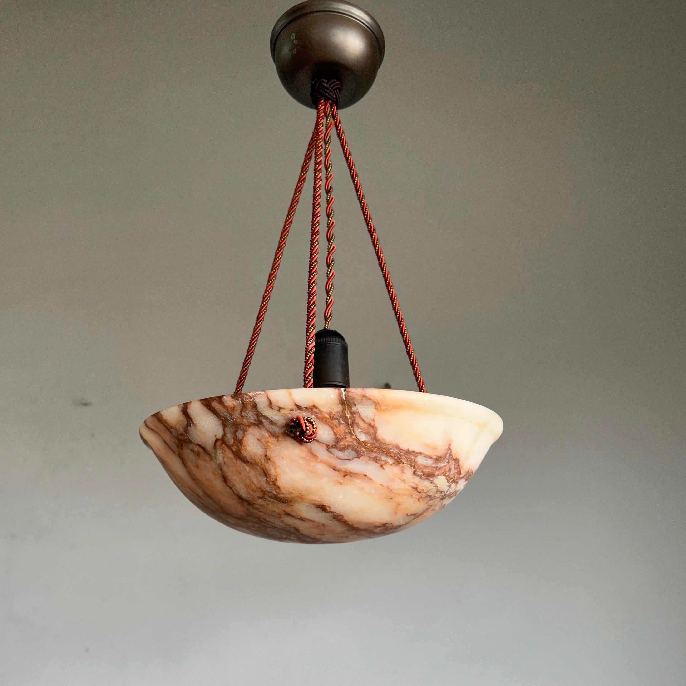 Beautifully rounded and amazing color pattern alabaster pendant.

If you are looking for a unique and great quality antique light fixture to grace your living space then this beautifully designed and all-handcrafted alabaster chandelier could be