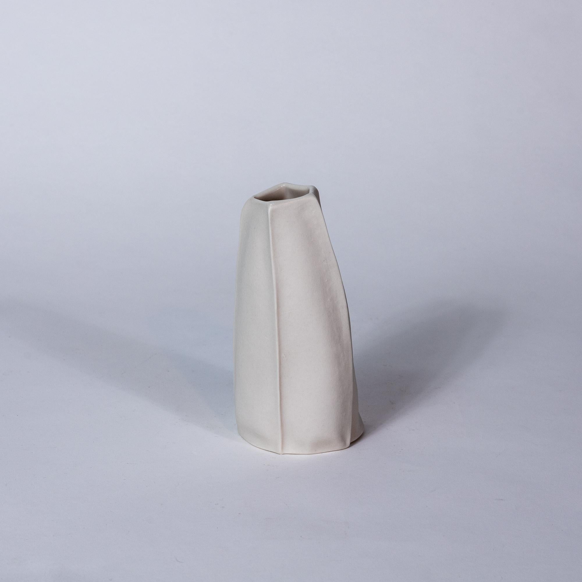 Organic white ceramic vase with textured raw porcelain exterior surface and clear glazed interior. 
Vases are watertight and will hold water for flower arrangements.

3