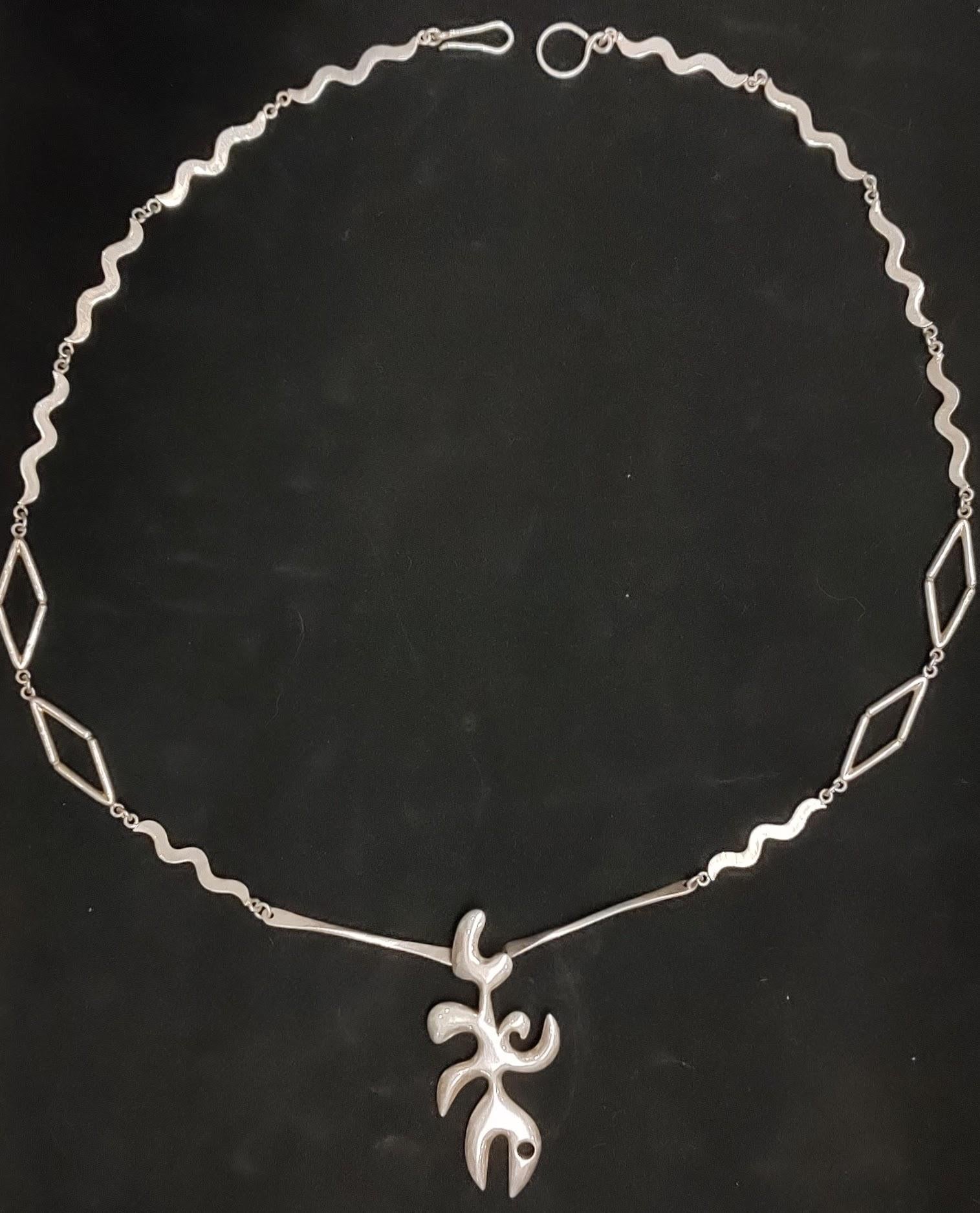 Very rare one-of-a-kind jewelry piece designed by the famous Mexican artist Alfredo Zalce ( Mexico 1908-2003), and depicts an abstract fish shape hanging from a very special chain made out of different elements linked together. This talented and