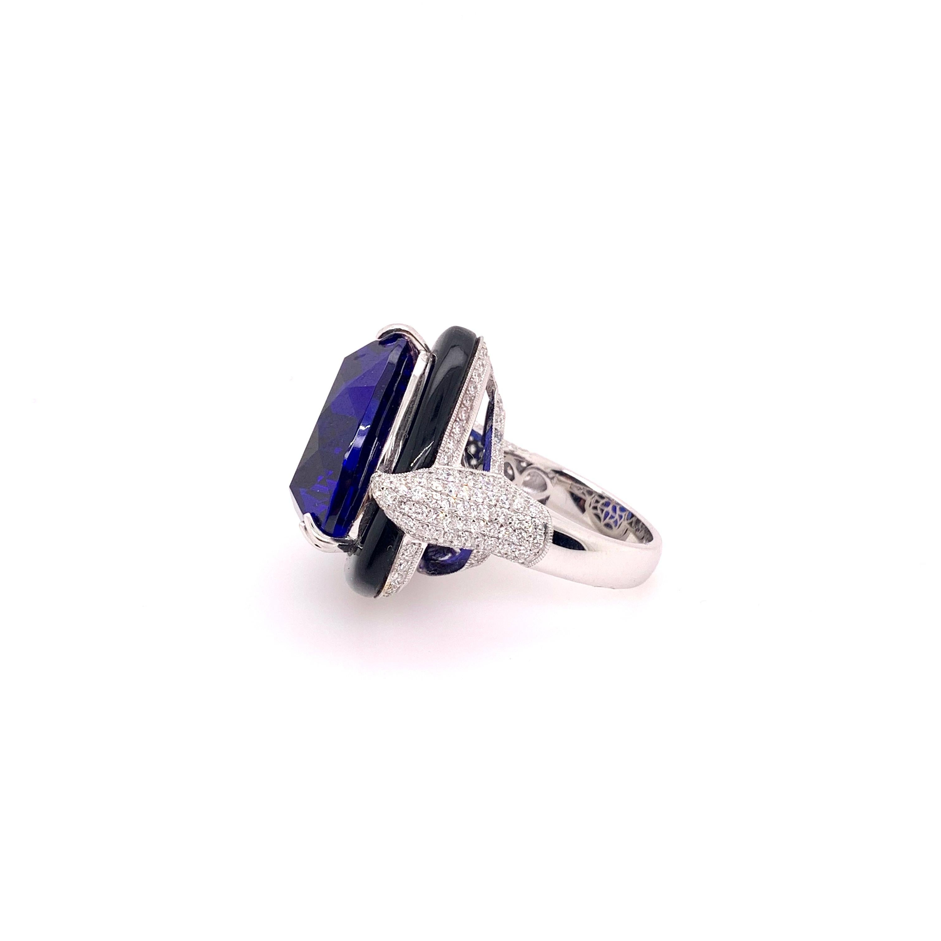 A masterpiece that will grasp everyone's attention!  18k White gold handmade tanzanite ring with custom cut onyx on the border and diamonds all around the setting.   The gigantic 41.5 ct. tanzanite is an unusual trillion cut that glistens at every