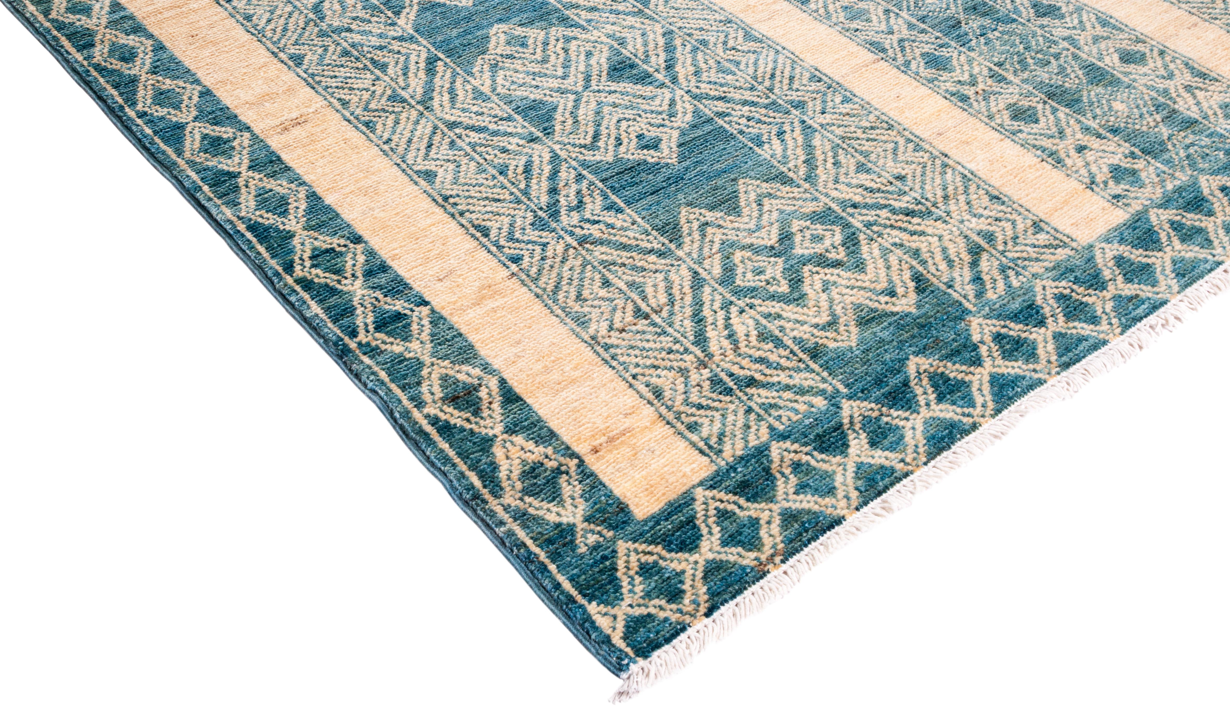 Color: Ivory - Made in: Pakistan. 100% wool. The rich textile tradition of western Africa inspired the Tribal collection of hand knotted rugs. Incorporating a medley of geometric motifs, in palettes ranging from earthy to vivacious, these rugs bring