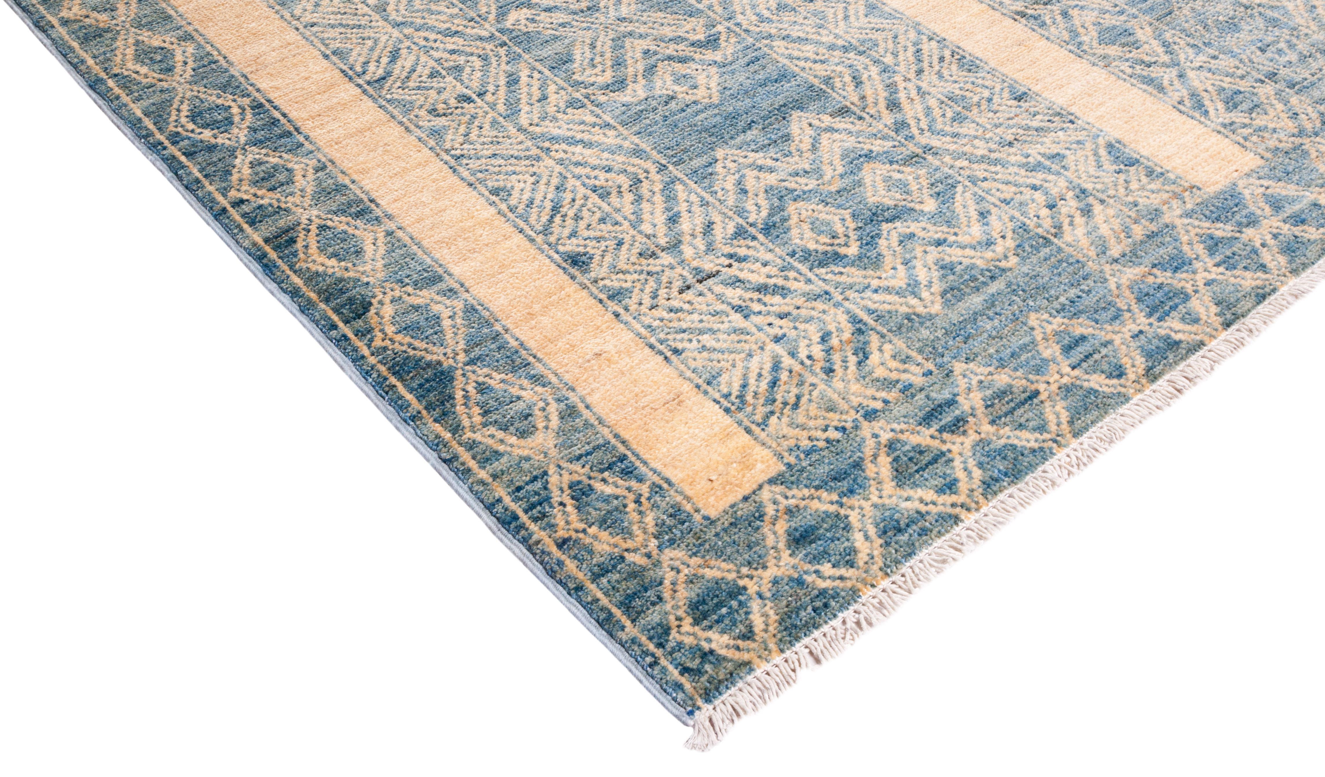 Color: Ivory, made in Pakistan. 100% wool. The rich textile tradition of western Africa inspired the Tribal collection of hand knotted rugs. Incorporating a medley of geometric motifs, in palettes ranging from earthy to vivacious, these rugs bring a