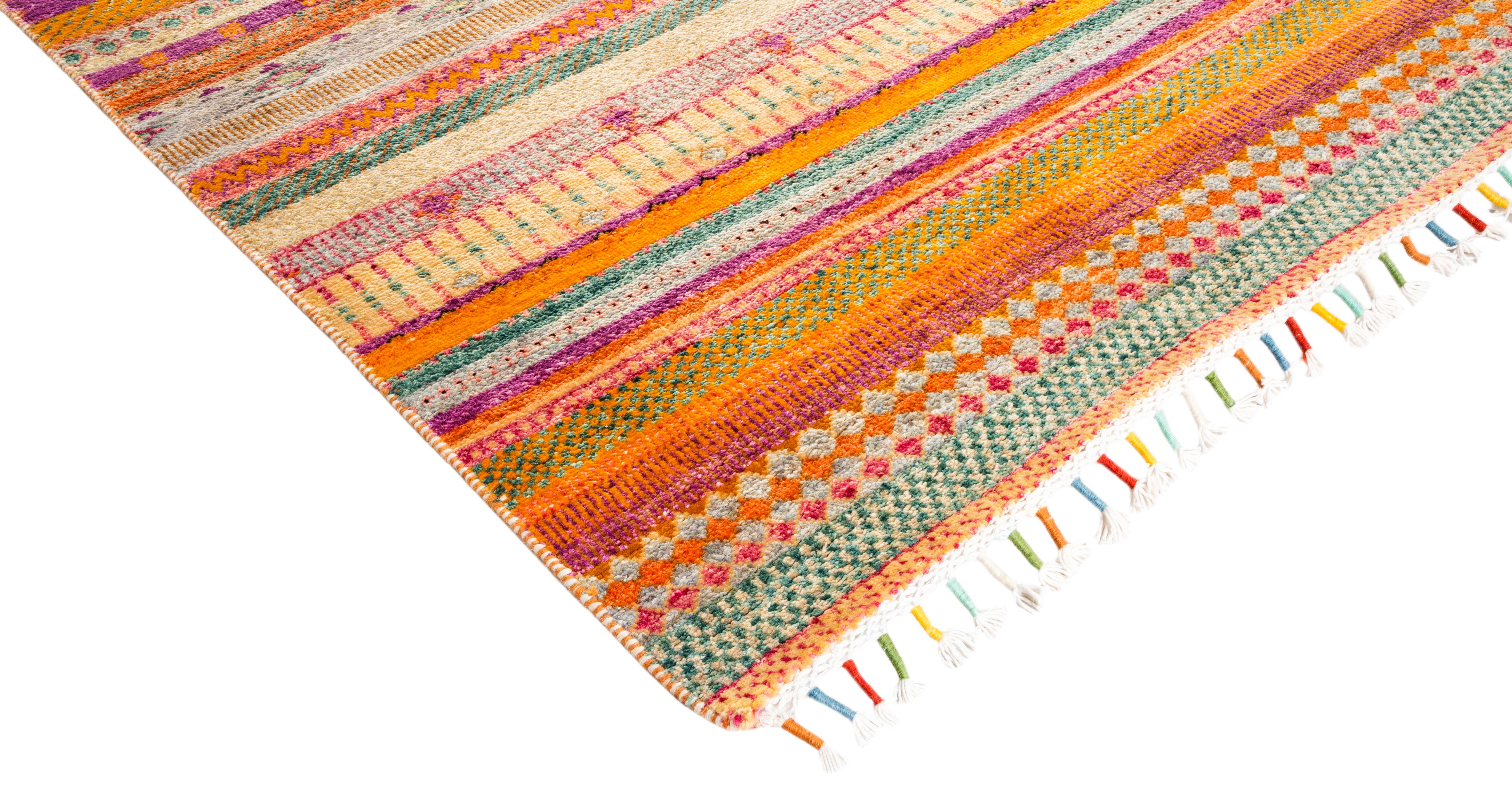 Color: Orange, made in: Pakistan. 100% wool. The rich textile tradition of western Africa inspired the Tribal collection of hand knotted rugs. Incorporating a medley of geometric motifs, in palettes ranging from earthy to vivacious, these rugs bring