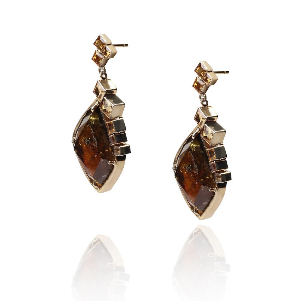 This unique pair of earrings was designed and hand made back in 2006 by Cristina Ramella herself. Its made around two unique and raw Turmalines purchased in NYC with a special setting and embellishment made with square citrines.