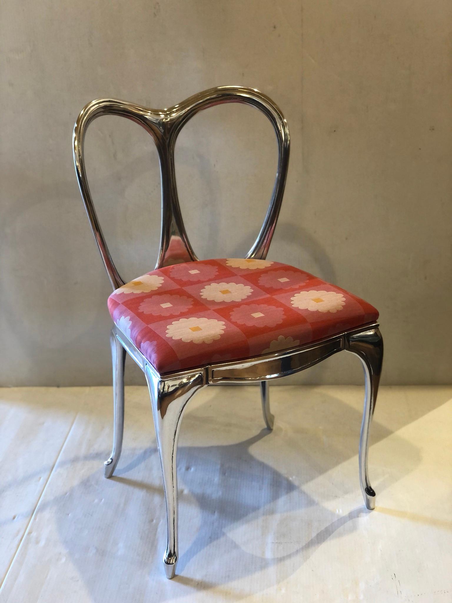 Beautiful and unique rare polished cast aluminum vanity chair, with new Maharam fabric this chair circa 1950s has been totally striped and polished to this chrome mirror finish, the shape and size its unique.