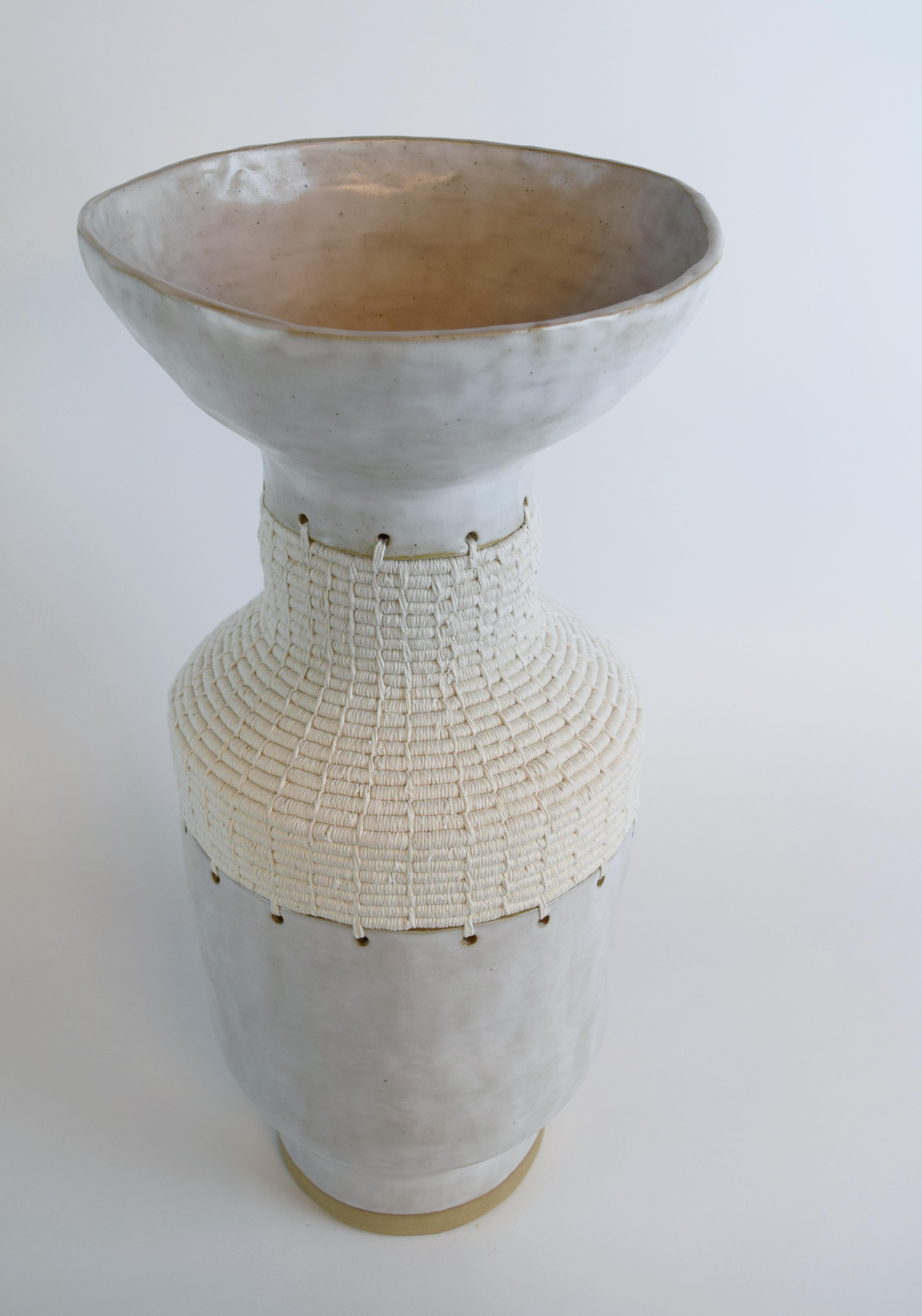 One of a kind vessel #751 by Karen Gayle Tinney

One of a kind hand-formed stoneware vessel with satin white glaze. Ceramic vessel is created by the artist using a hand-building technique (without the use of moulds or a wheel), resulting in a true