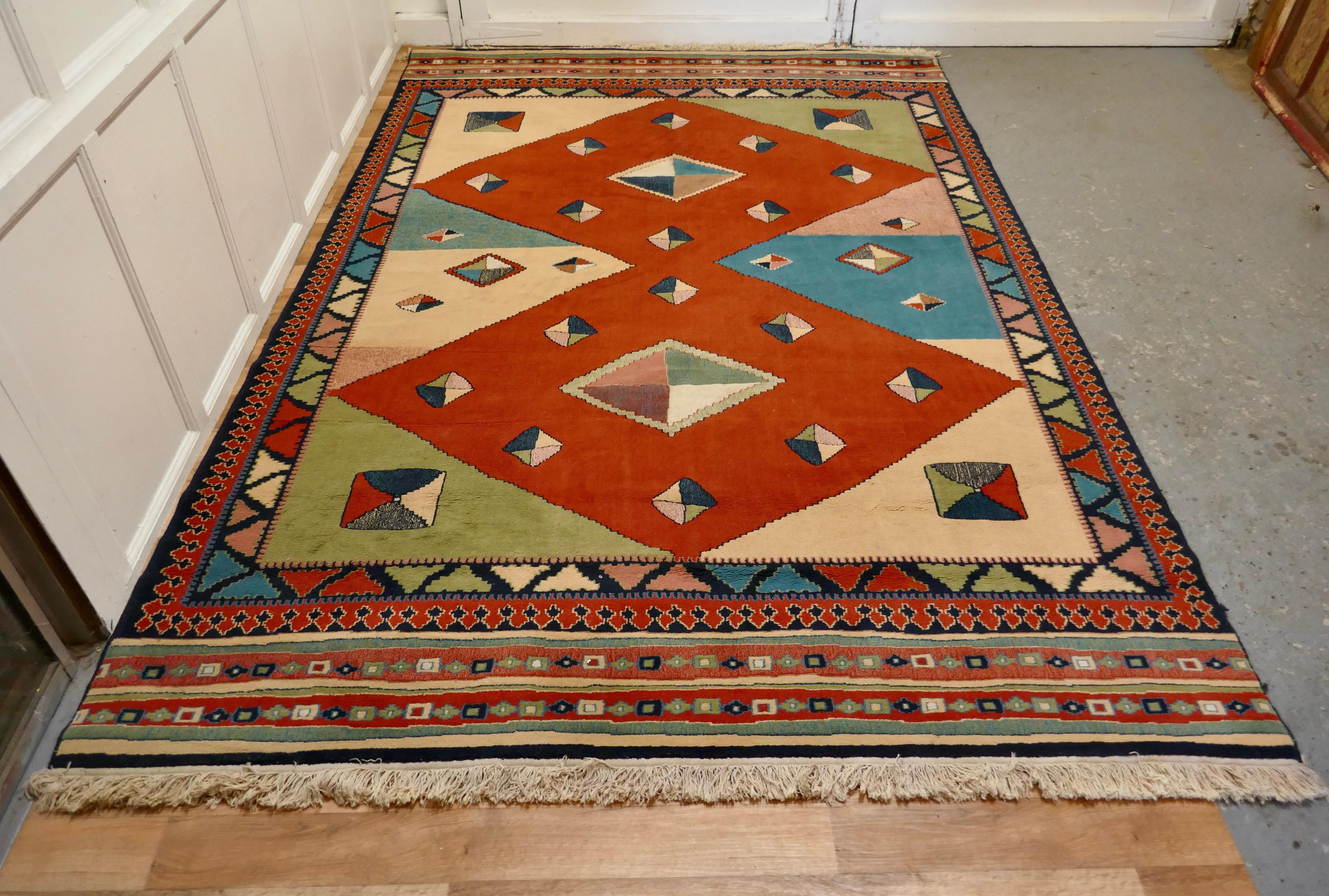 One of a kind vintage multi colored retro cubist carpet 

A superb looking piece dating from the 20th Century and has a lovely colour palette with orange diamonds and a hint to the east with an islamic border pattern
This is a Wool Rug has large