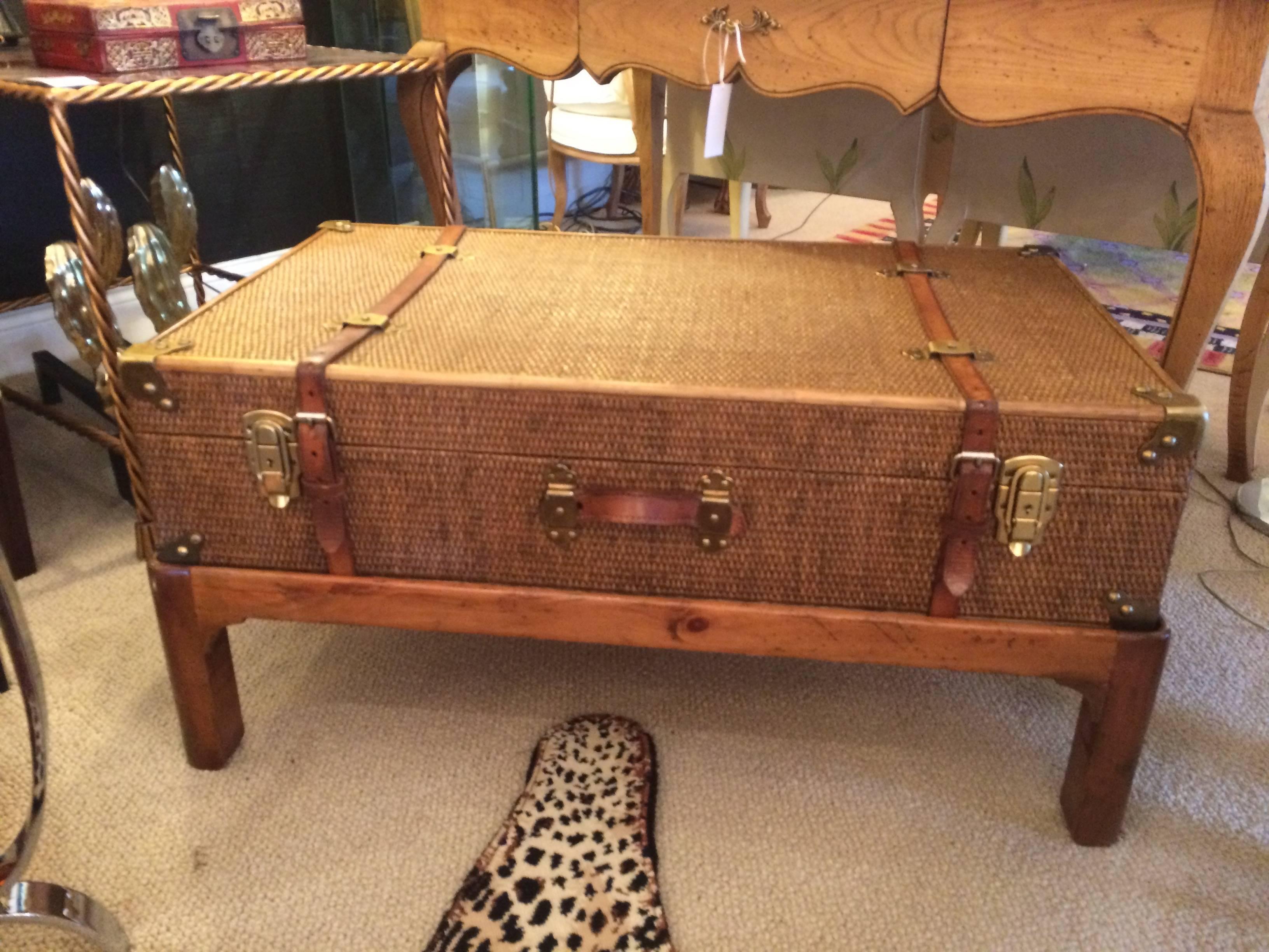 Ralph Lauren style coffee or accent table comprised of a vintage rattan suitcase on custom base. Suitcase has the original leather straps, handle and clasps. Brass trim at each corner. Newly restored -- looks gorgeous!