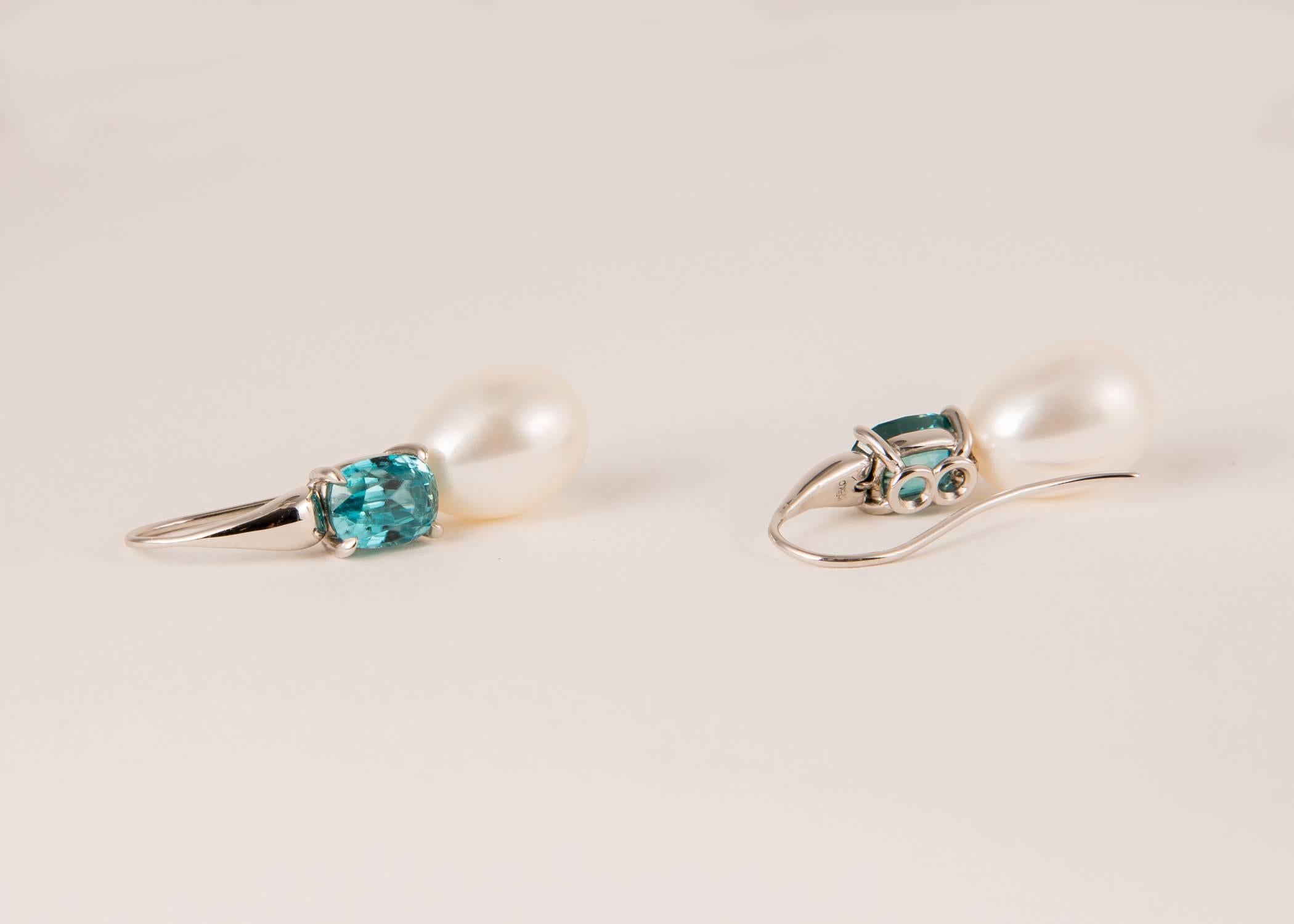 Handmade 18k white gold earrings featuring a matched pair of fiery blue zircons and a pair of cultured freshwater pearls. Simply elegant !!! 1 1/4 inches in length