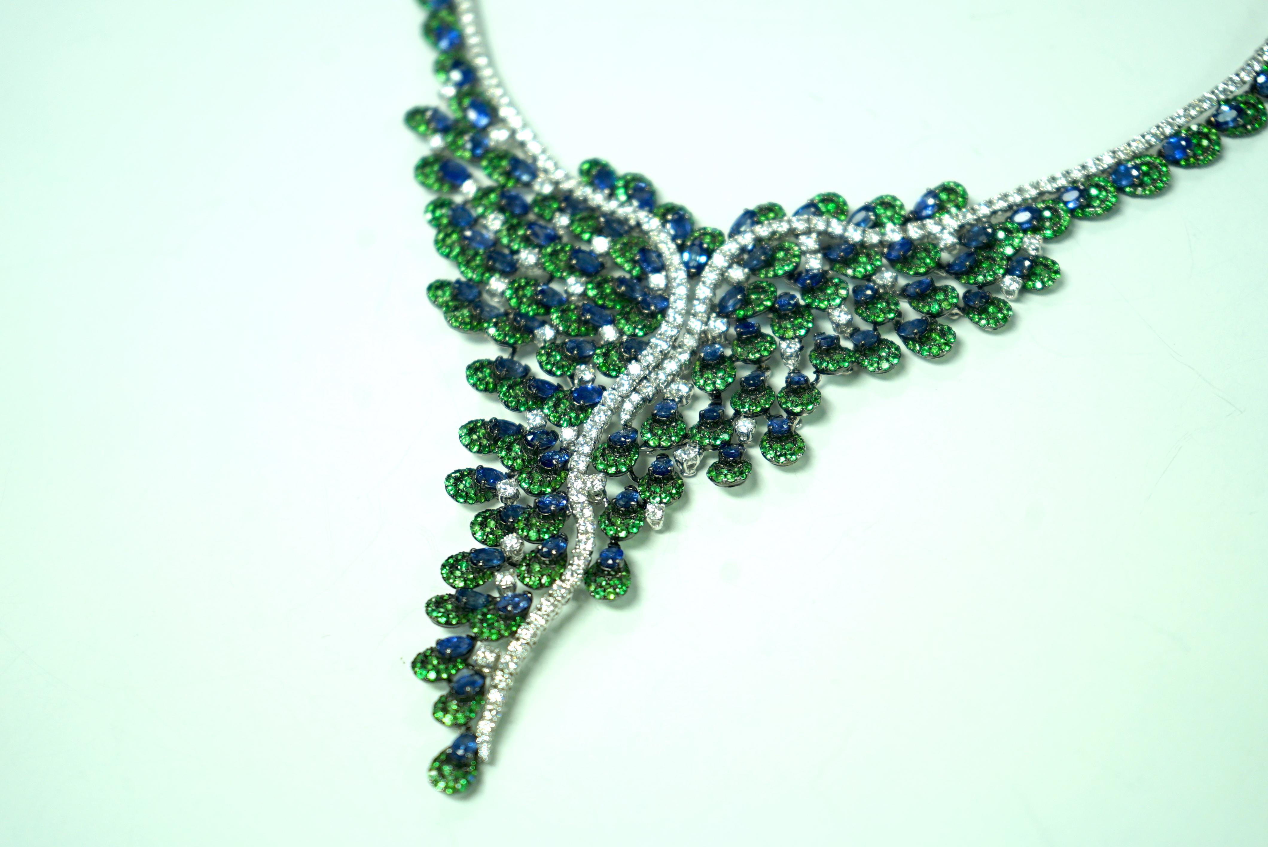 What a magnificent necklace by famed designer Yvel, from the Peacock Collection!  With over 12.00 carats of diamonds and almost 50.00 carats of blue sapphires, this enchanting necklace also features beautiful green tsavorite stones!
The current