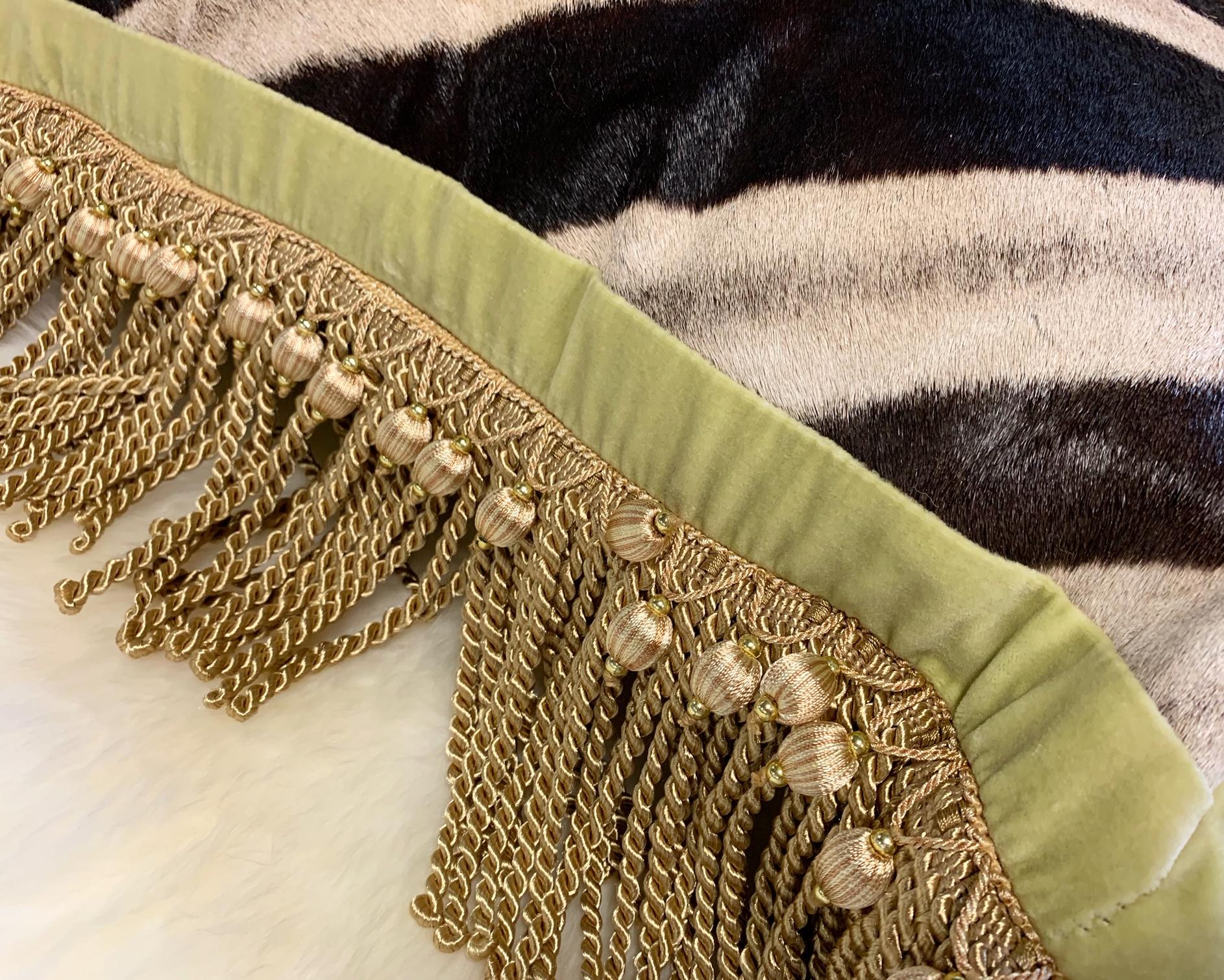 Forsyth zebra hide pillows are simply the best. The most beautiful hides are selected, handcut, handstitched, and hand stuffed with the finest goose down. Each step is meticulously curated by Saint Louis based Forsyth artisans. This gold fringe and